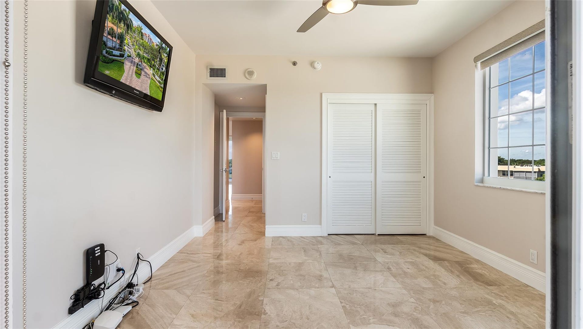 4116 W Palm Aire Drive, #166b, Pompano Beach, FL 33069 Bedroom 2: Light-filled guest room with double closet, ceiling fan, and elegant tile flooring for year-round comfort.