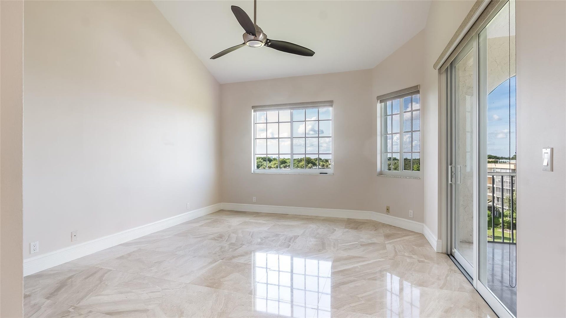 4116 W Palm Aire Drive, #166b, Pompano Beach, FL 33069 Primary Bed: Large picture window fills the room with natural light and frames tranquil treetop views.