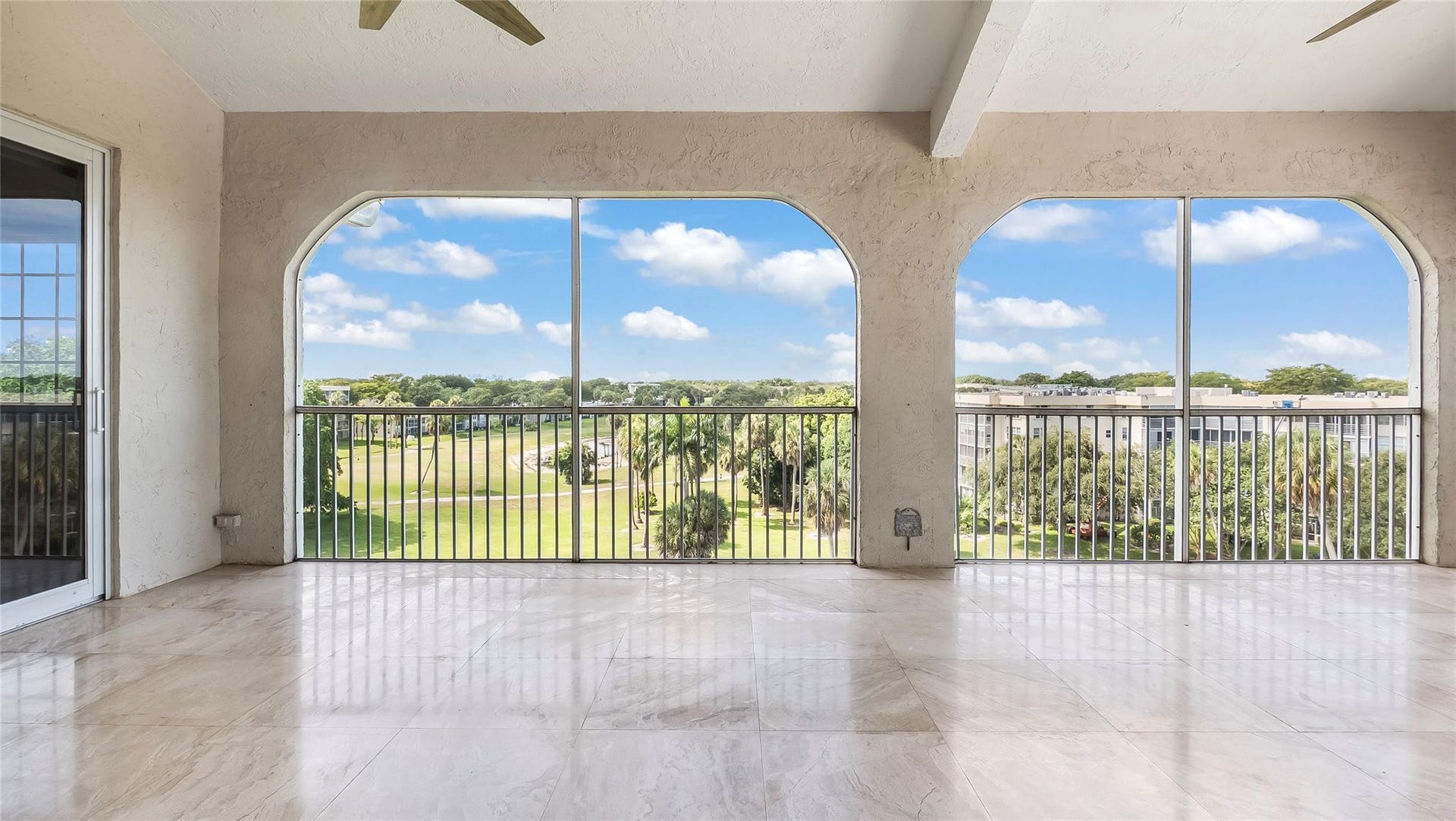 4116 W Palm Aire Drive, #166b, Pompano Beach, FL 33069 Centered vantage captures the full depth of the space and highlights the lush scenery beyond.