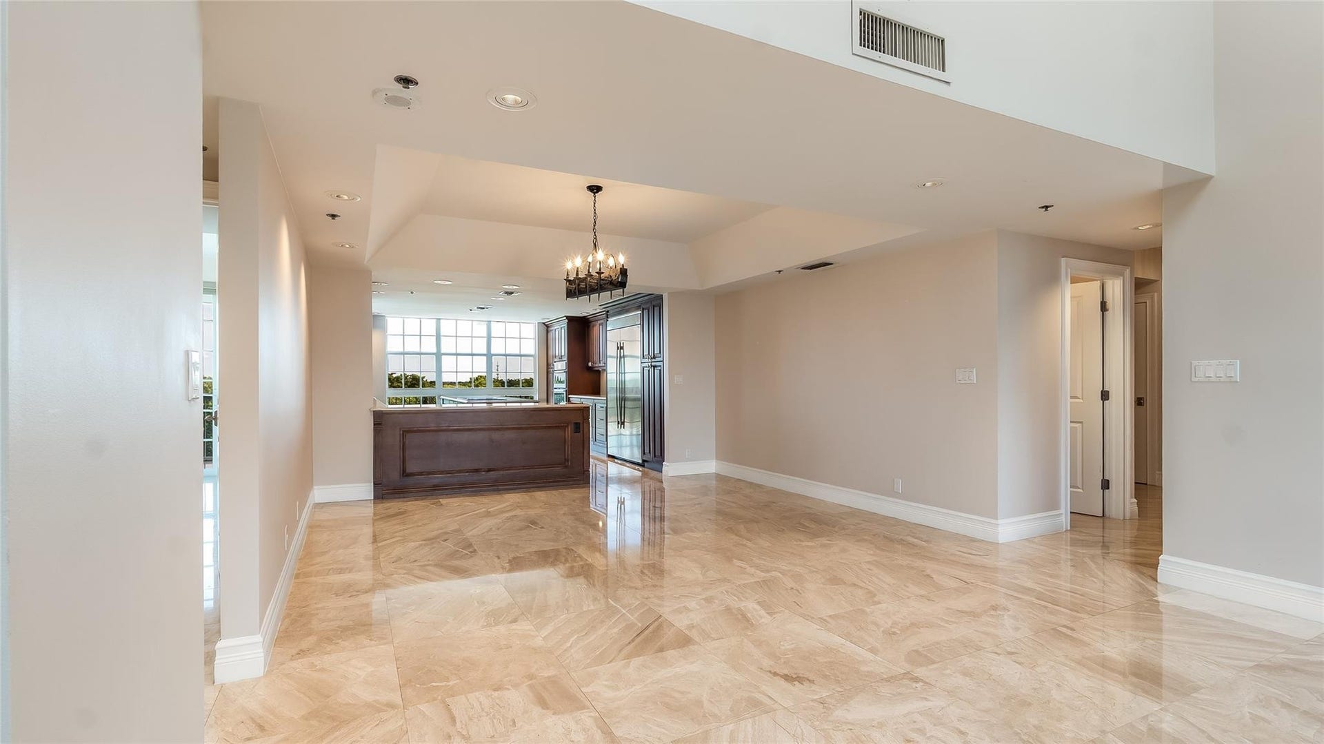 4116 W Palm Aire Drive, #166b, Pompano Beach, FL 33069 Rich wood cabinetry and expansive windows in the adjacent kitchen create a warm and inviting backdrop for meals and gatherings.