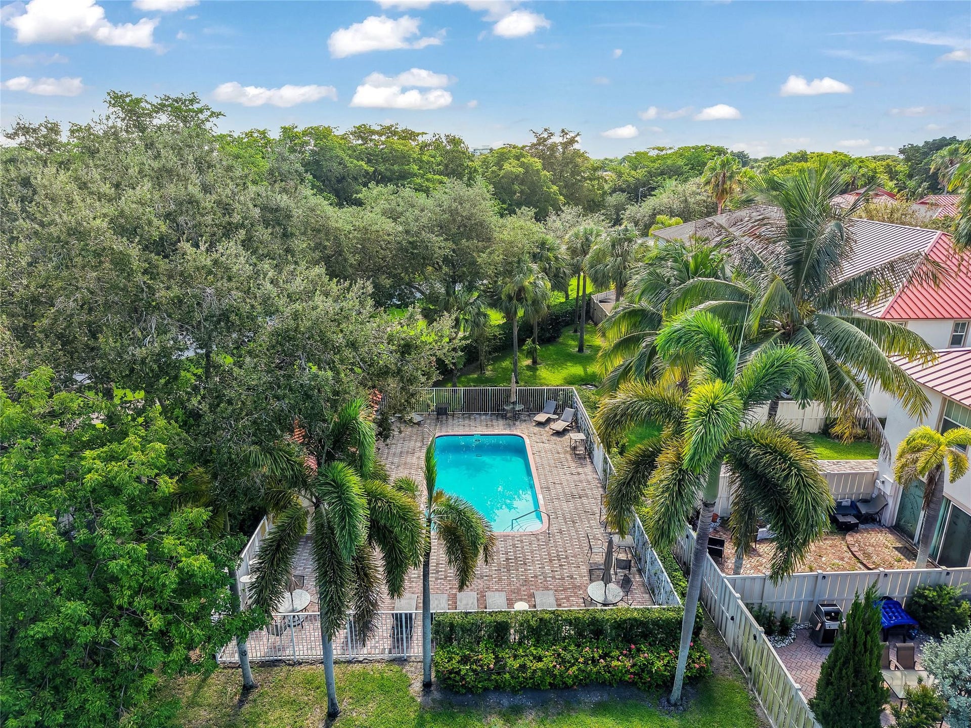 4116 W Palm Aire Drive, #166b, Pompano Beach, FL 33069 Residents enjoy access to a private community pool surrounded by a spacious brick deck, lush landscaping, and plenty of seating areas.