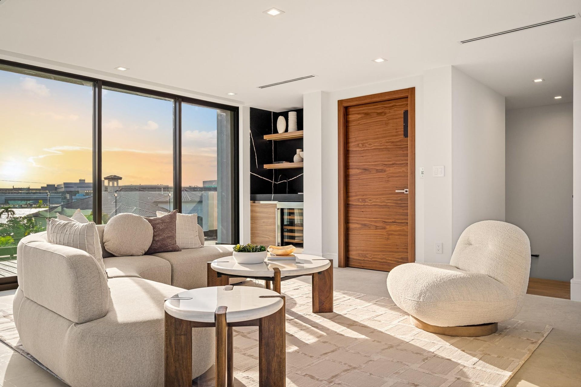 2000 Harbourview Drive, Fort Lauderdale, FL 33316 An elegant upper-level retreat featuring a private wet bar, warm wood accents, and expansive sliding glass doors opening to breathtaking water views. Sophisticated and serene, this refined lounge offers the perfect setting for elevated relaxation and sunset entertaining.