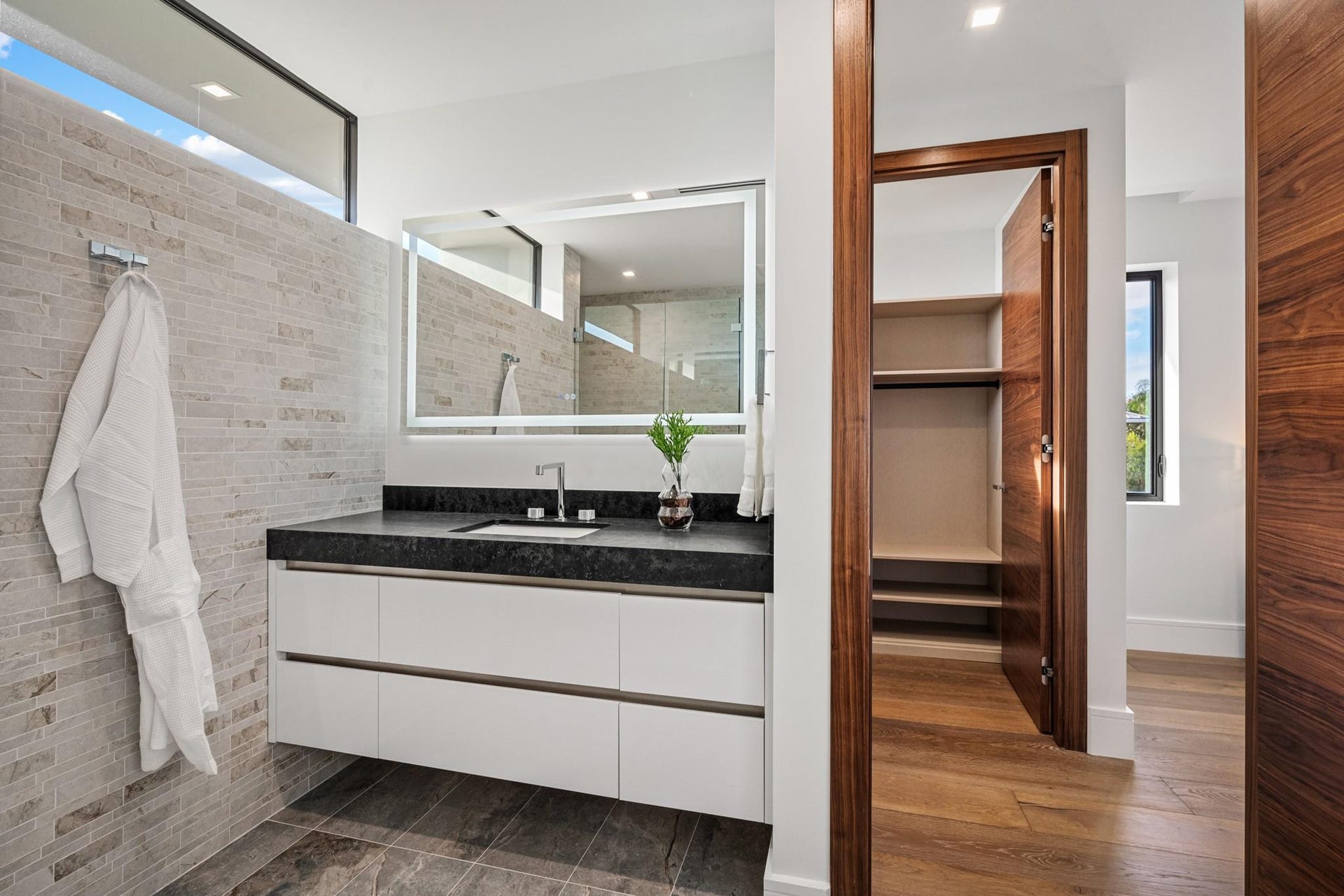 2000 Harbourview Drive, Fort Lauderdale, FL 33316 A sleek contemporary bath featuring a floating vanity with integrated lighting, minimalist hardware, and crisp modern finishes. Clean, bright, and thoughtfully designed, this elegant space delivers understated luxury with spa-inspired appeal.