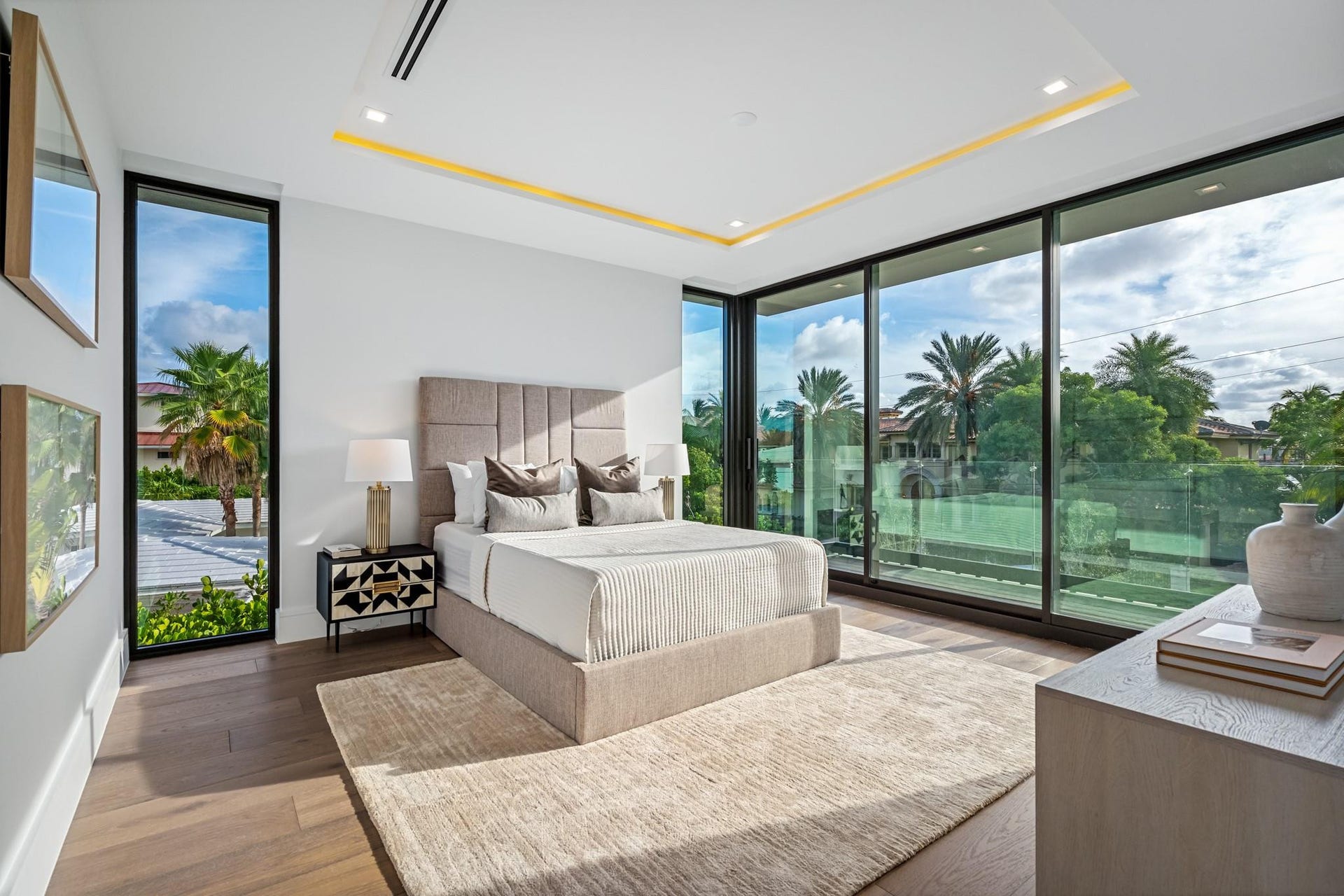 2000 Harbourview Drive, Fort Lauderdale, FL 33316 A bright and contemporary guest bedroom featuring floor-to-ceiling glass and direct access to a private balcony overlooking lush greenery. Airy and refined, this serene retreat offers guests their own elevated indoor-outdoor escape.