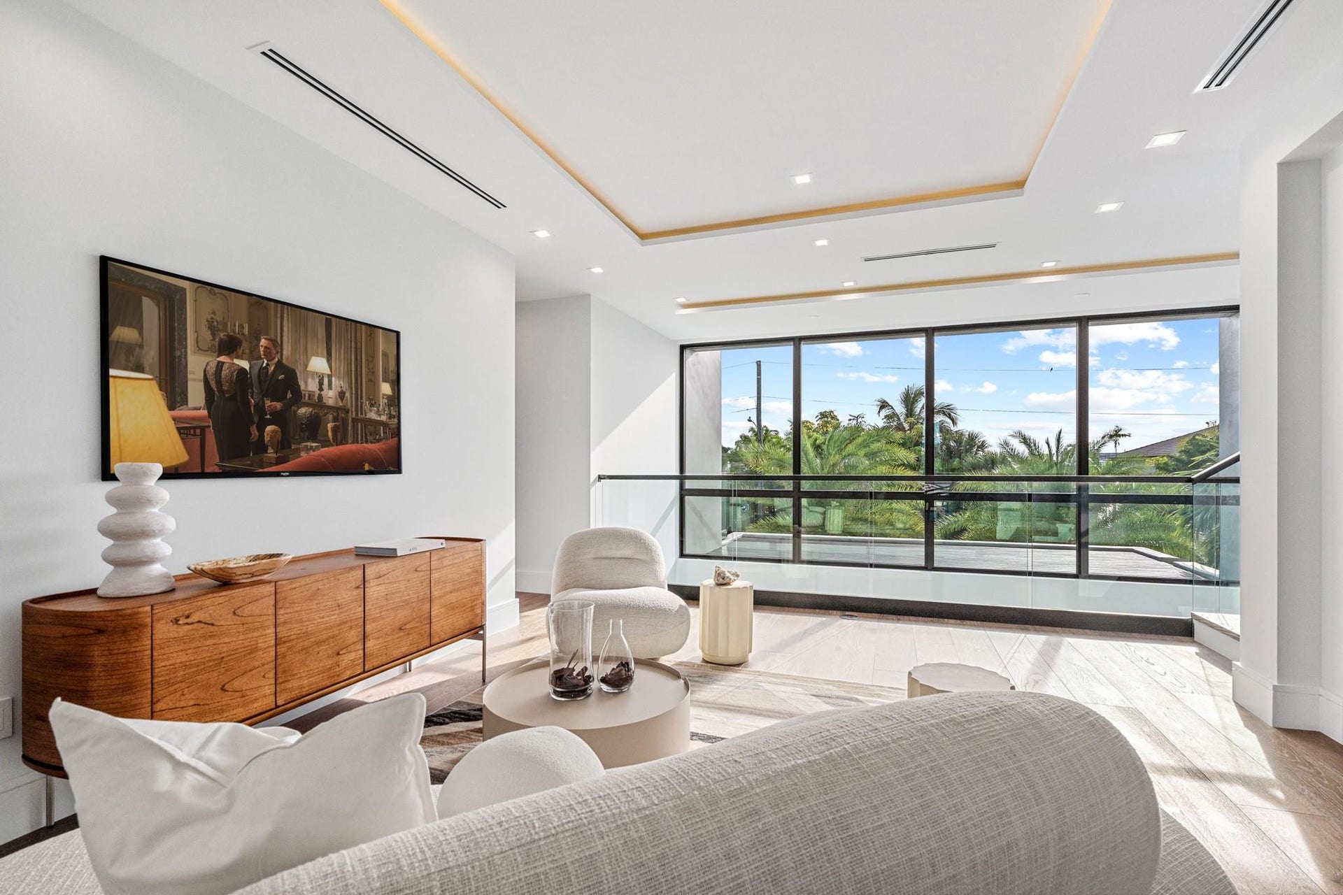 2000 Harbourview Drive, Fort Lauderdale, FL 33316 A serene waterfront bedroom showcasing clean modern lines, warm wood accents, and expansive windows framing tranquil water views. Bright and beautifully appointed, this private retreat blends contemporary elegance with a peaceful coastal backdrop.