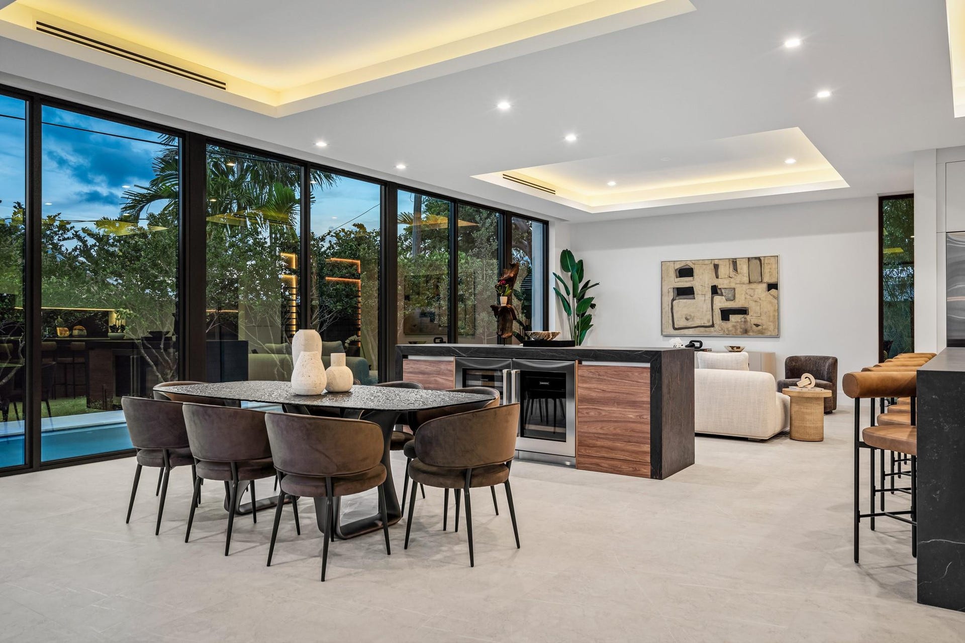 2000 Harbourview Drive, Fort Lauderdale, FL 33316 A sophisticated dining space seamlessly integrated into the open-concept design, framed by floor-to-ceiling glass and tranquil garden views. Warm wood tones and clean contemporary lines create an inviting setting for refined indoor-outdoor entertaining.