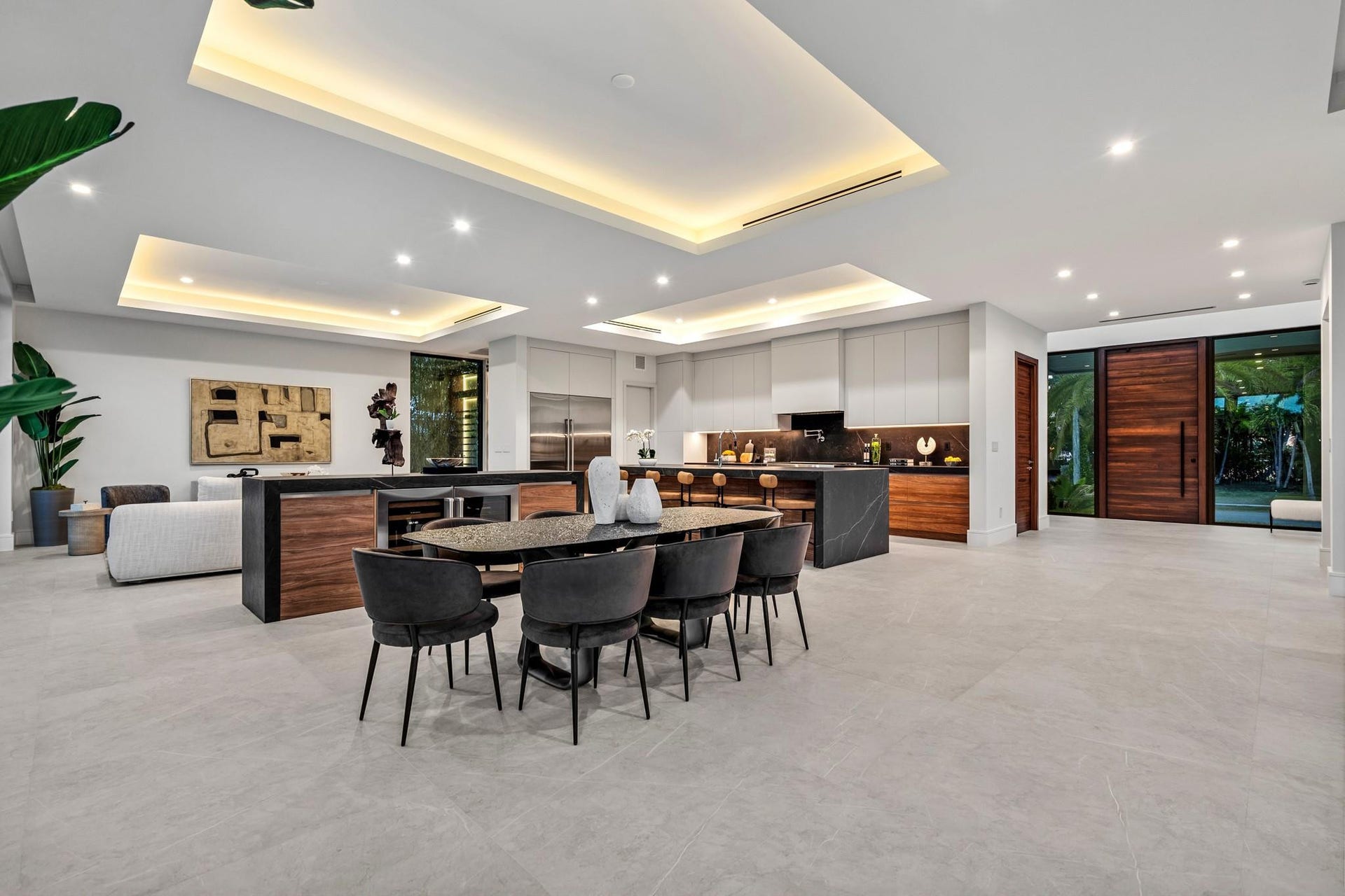 2000 Harbourview Drive, Fort Lauderdale, FL 33316 An expansive open living and dining area anchored by a sleek designer kitchen with statement island and warm wood cabinetry. Clean architectural lines, recessed lighting, and seamless indoor-outdoor flow create a sophisticated setting for modern entertaining.