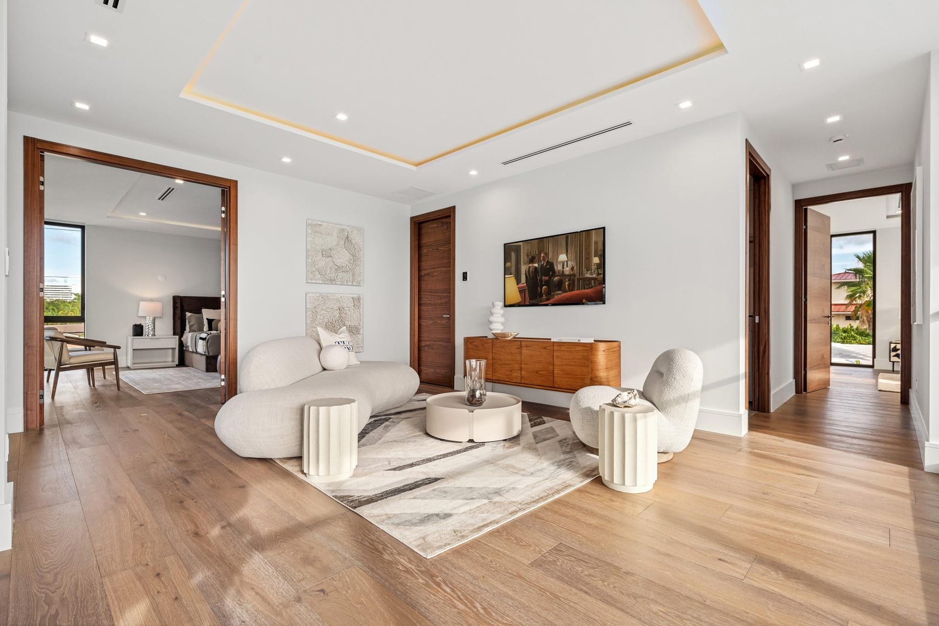 2000 Harbourview Drive, Fort Lauderdale, FL 33316 A spacious contemporary living area featuring warm wood floors, soft neutral tones, and clean architectural detailing throughout. Open and inviting, this refined space seamlessly connects to the adjoining suite for elevated comfort and modern elegance.