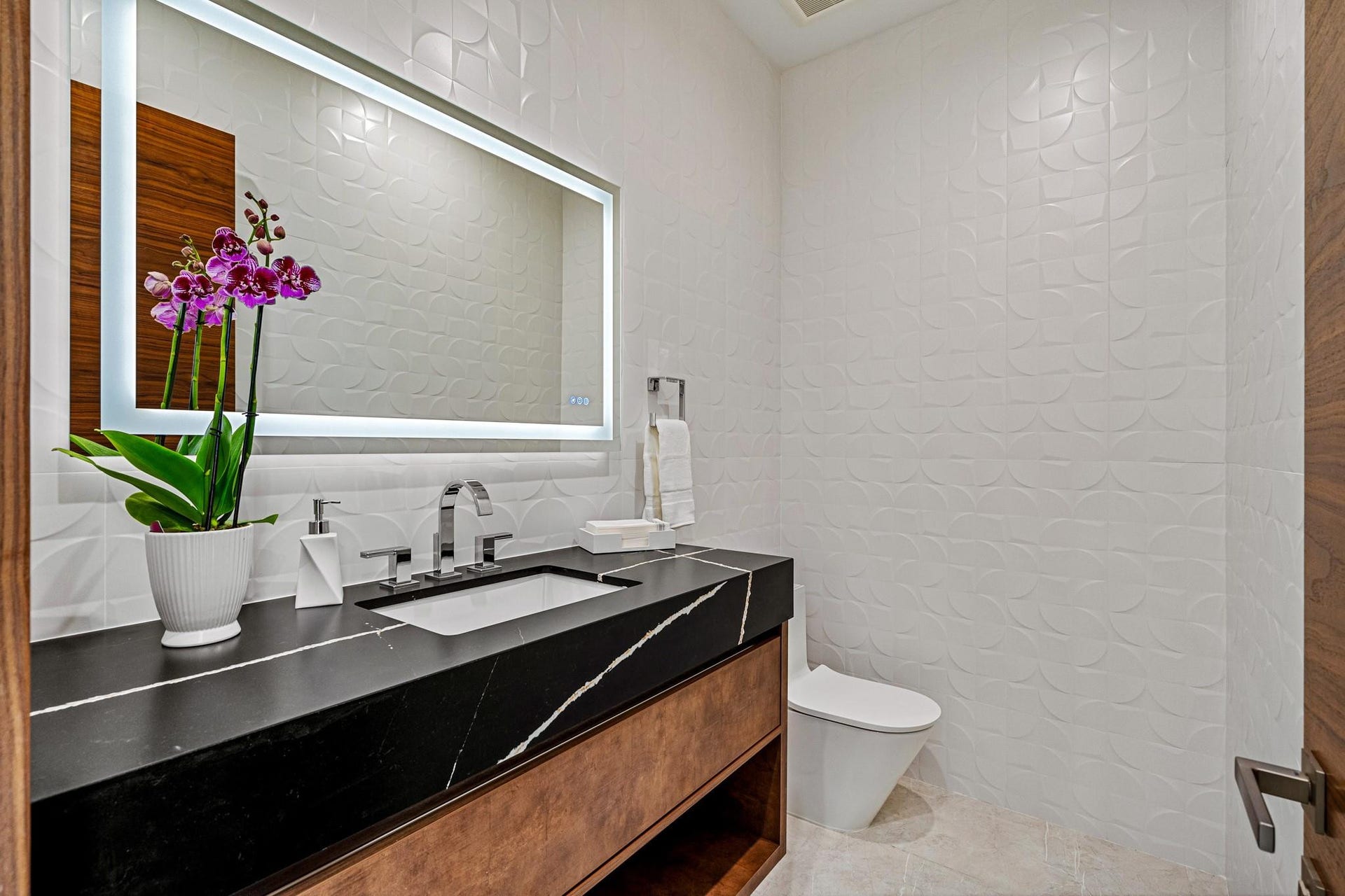2000 Harbourview Drive, Fort Lauderdale, FL 33316 A sleek and stylish powder room featuring a floating vanity, bold contrasting finishes, and a clean, modern aesthetic. Thoughtfully designed, this refined space adds a touch of contemporary elegance for guests.