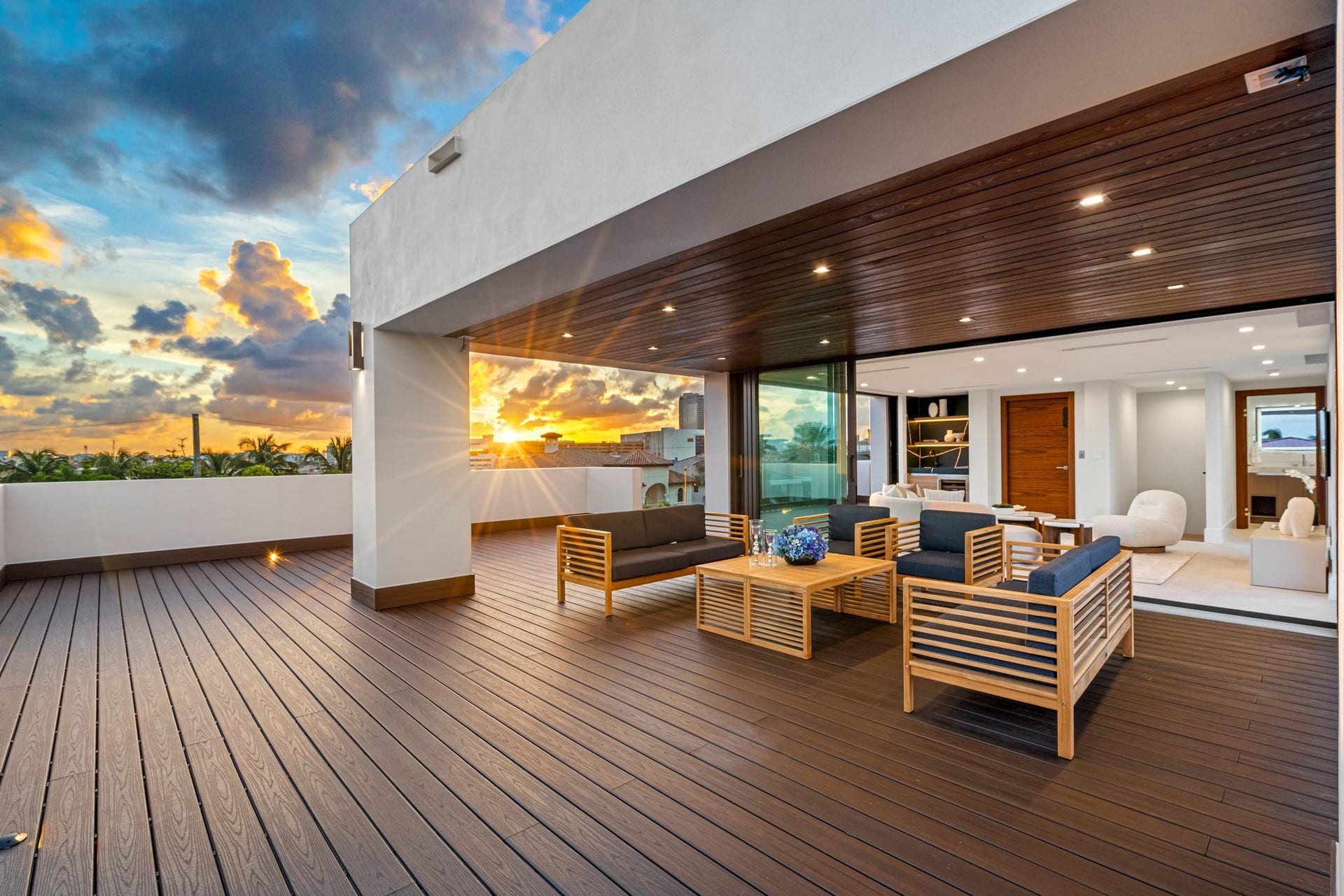 2000 Harbourview Drive, Fort Lauderdale, FL 33316 An expansive covered terrace featuring warm wood ceilings, elegant lounge seating, and seamless flow to the open-air deck beyond. Framed by breathtaking sunset skies, this sophisticated outdoor retreat is designed for elevated entertaining and relaxed coastal evenings.