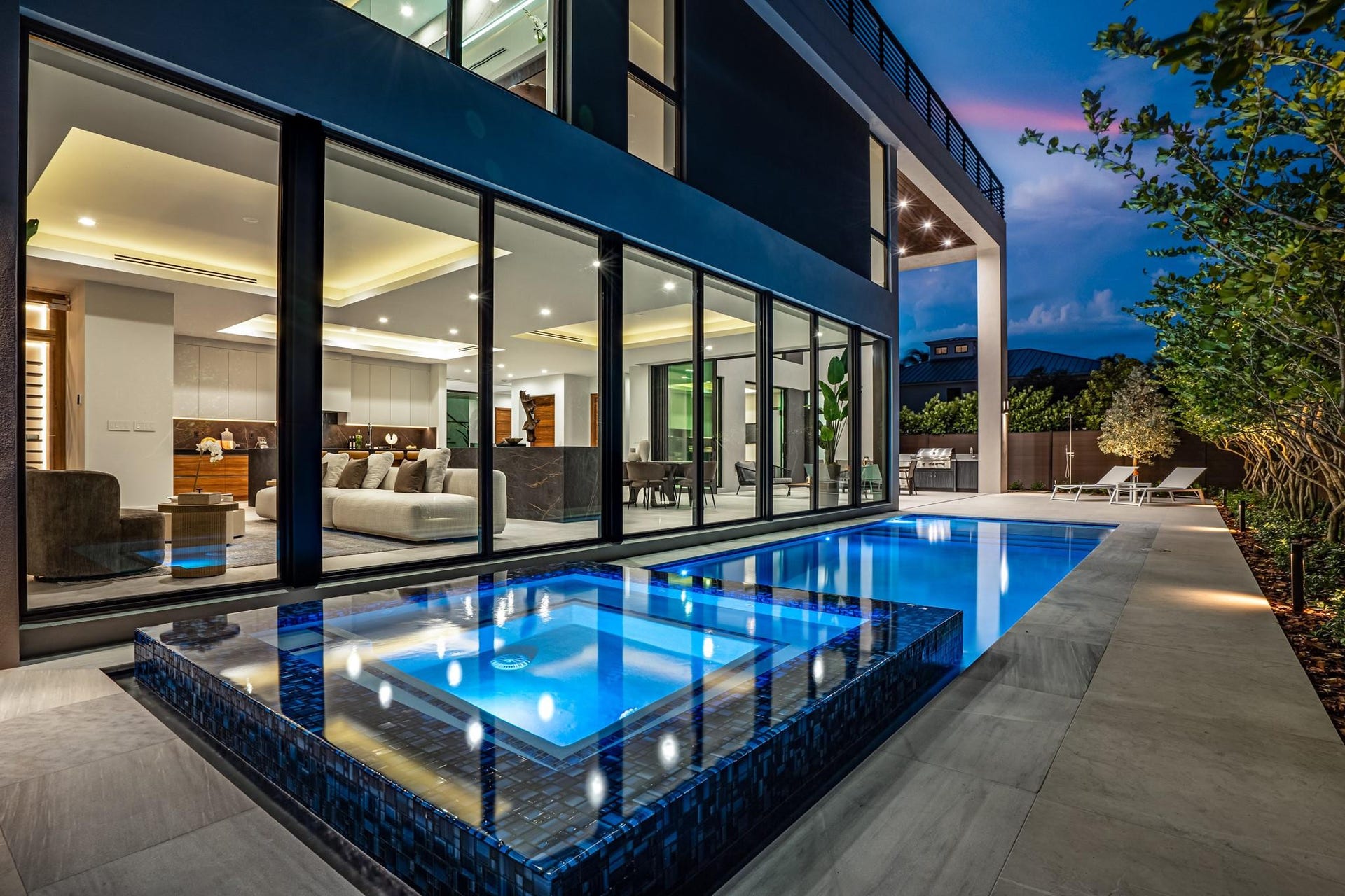 2000 Harbourview Drive, Fort Lauderdale, FL 33316 A dramatic evening poolscape framed by floor-to-ceiling glass walls that dissolve the boundary between indoors and out. Sleek, modern, and illuminated to perfection, this stunning setting captures the essence of sophisticated living after dark.