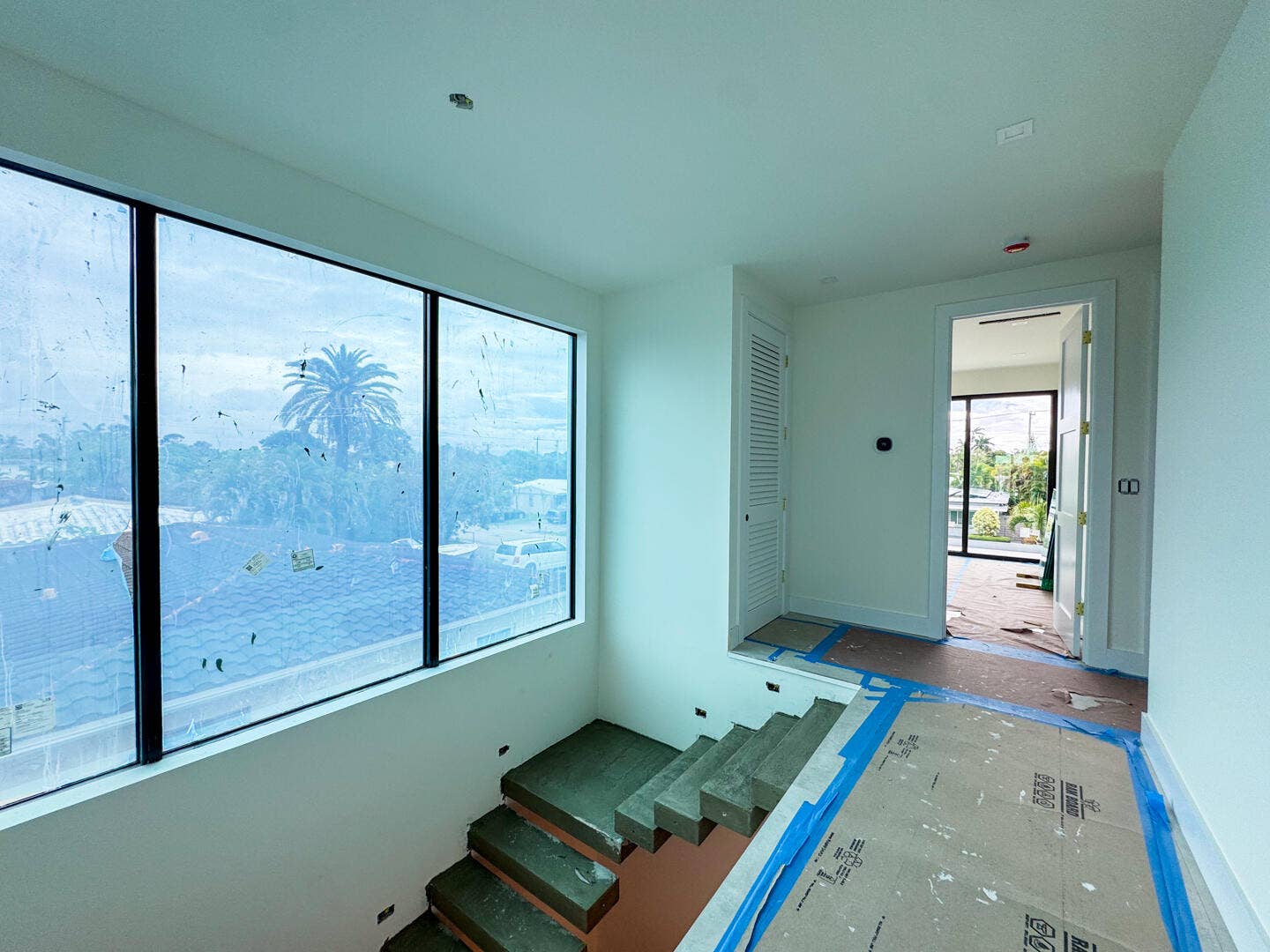 (as of April 8, 2026) the second level is seamlessly connected by the floating concrete staircase, with light pouring in from the full-height picture windows
