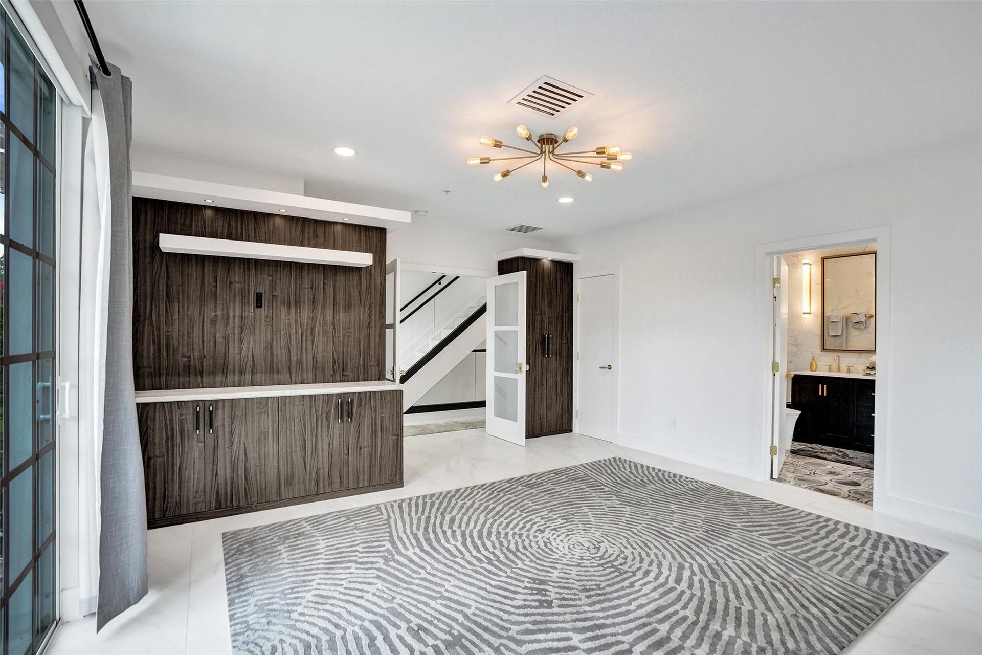 Primary suite with balcony and natural light.