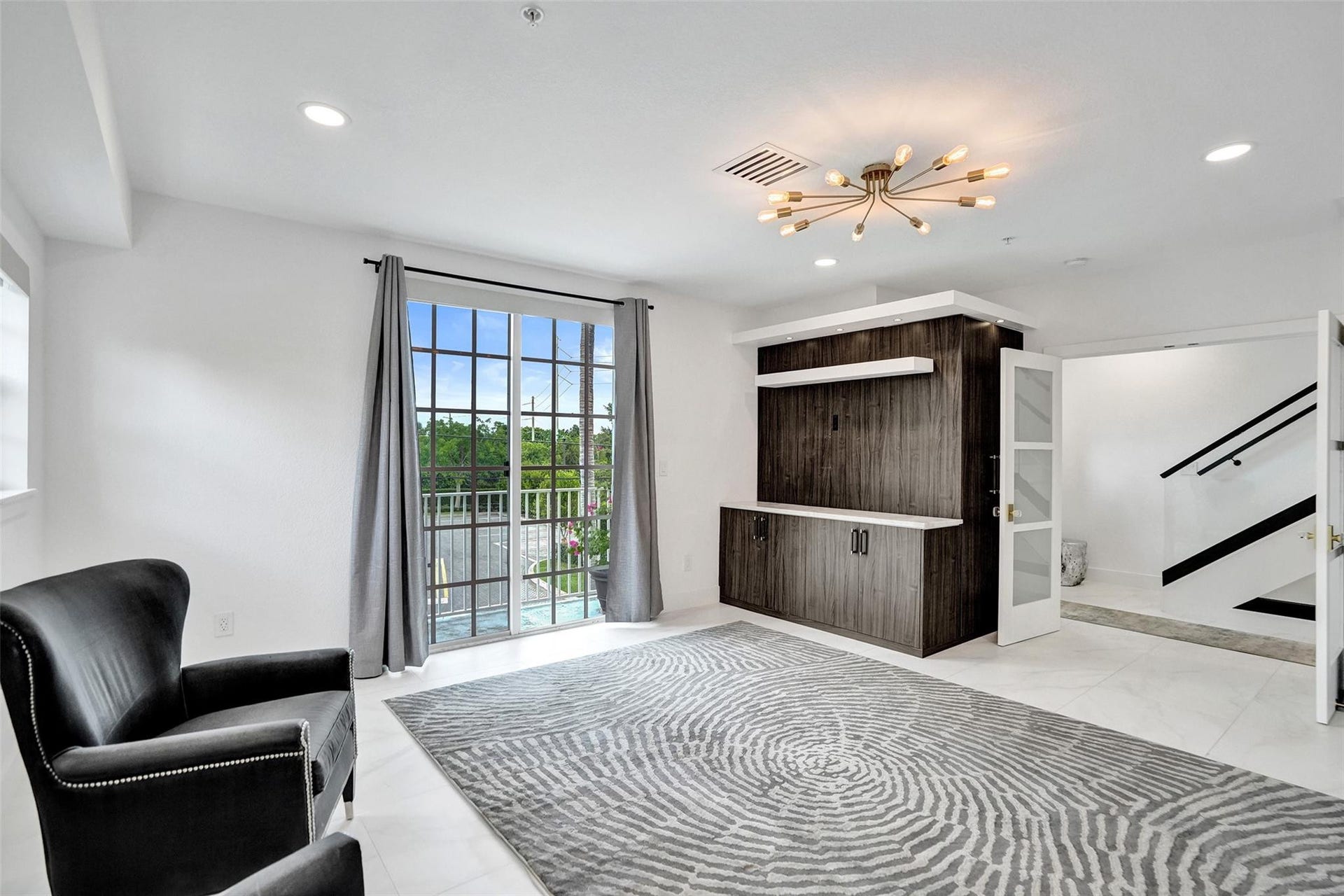 Primary suite with balcony and natural light.