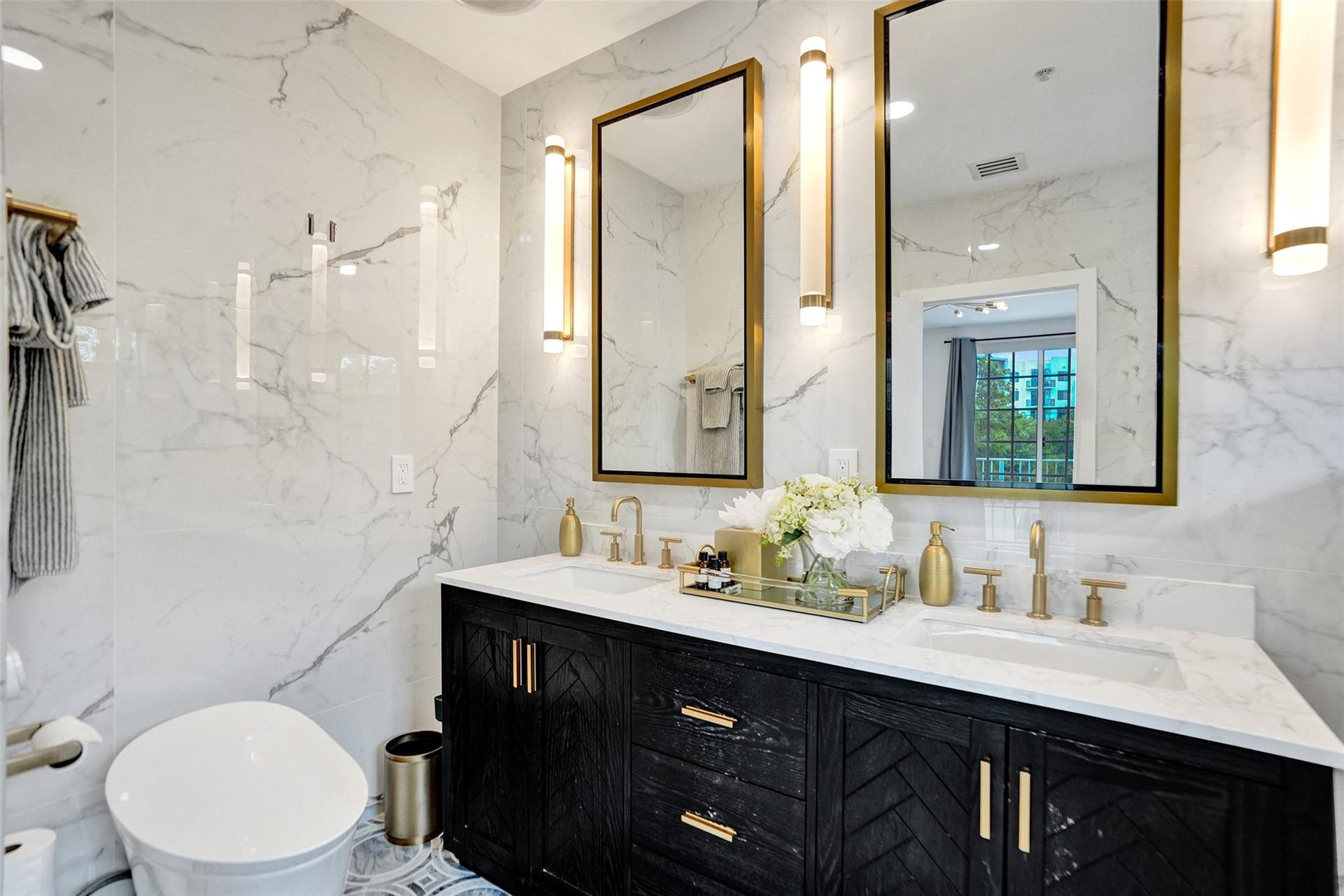 Spa-like primary bath with dual shower heads and marble tile.