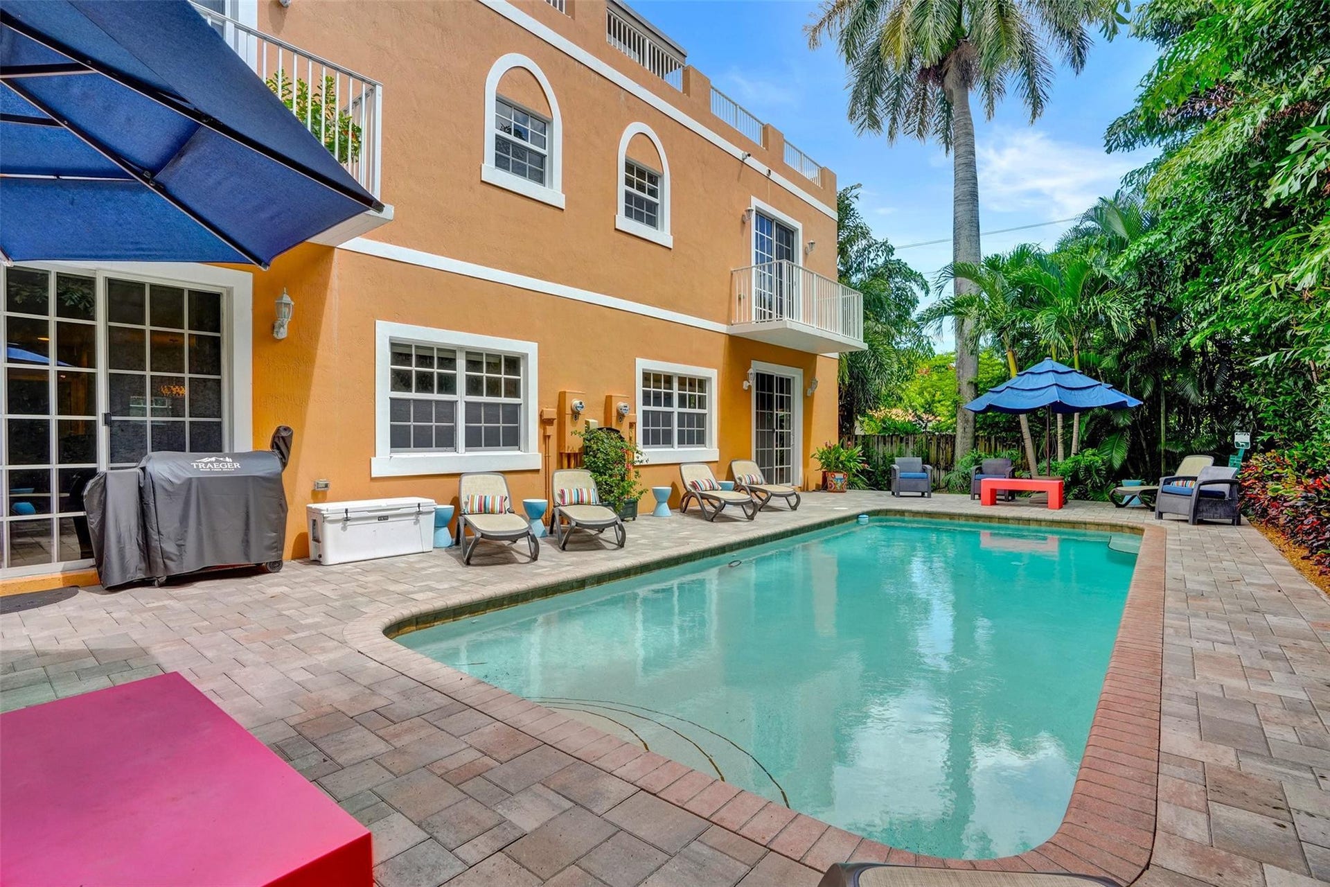 Community pool with lush landscaping.