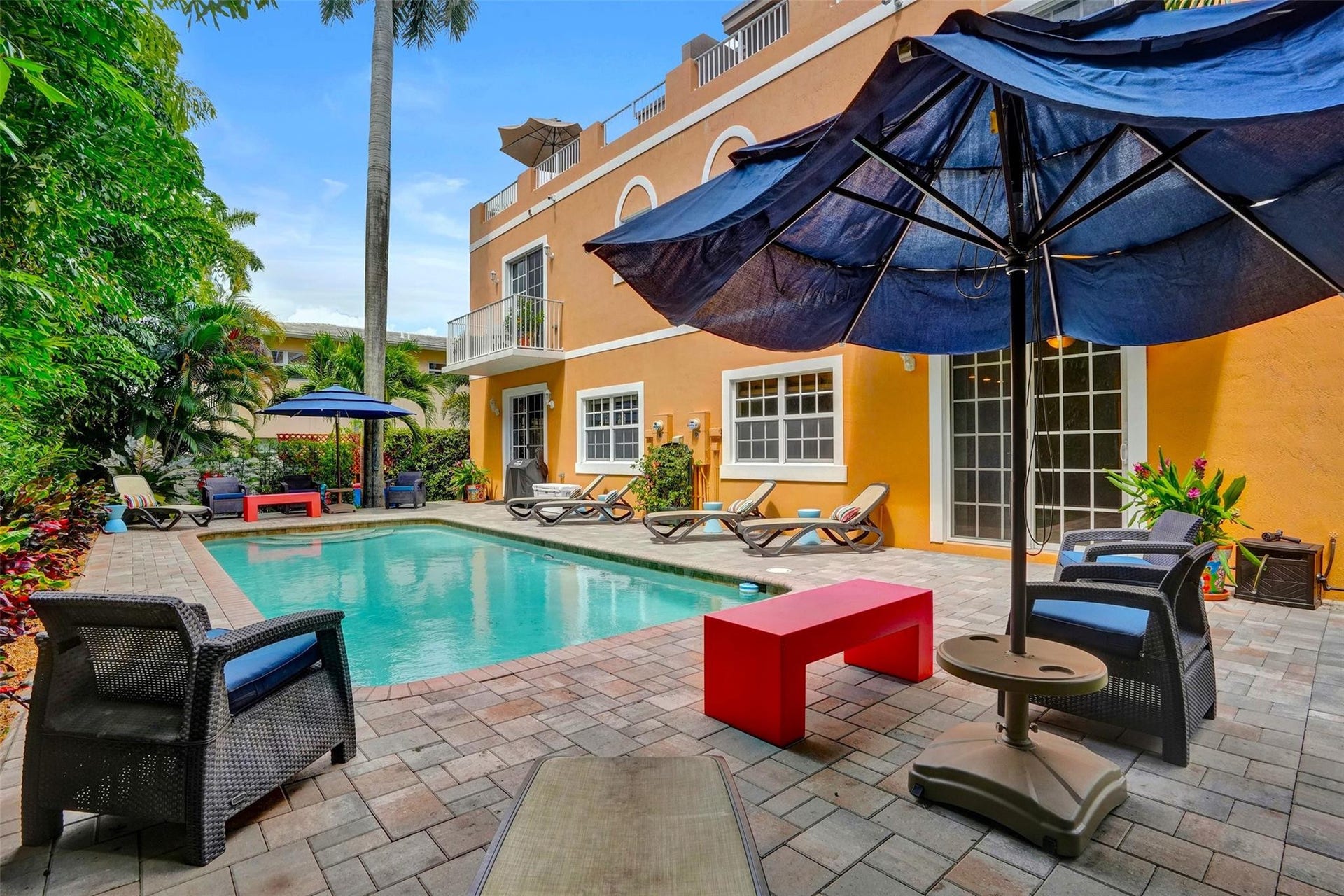 Poolside seating with umbrellas and lounge chairs.