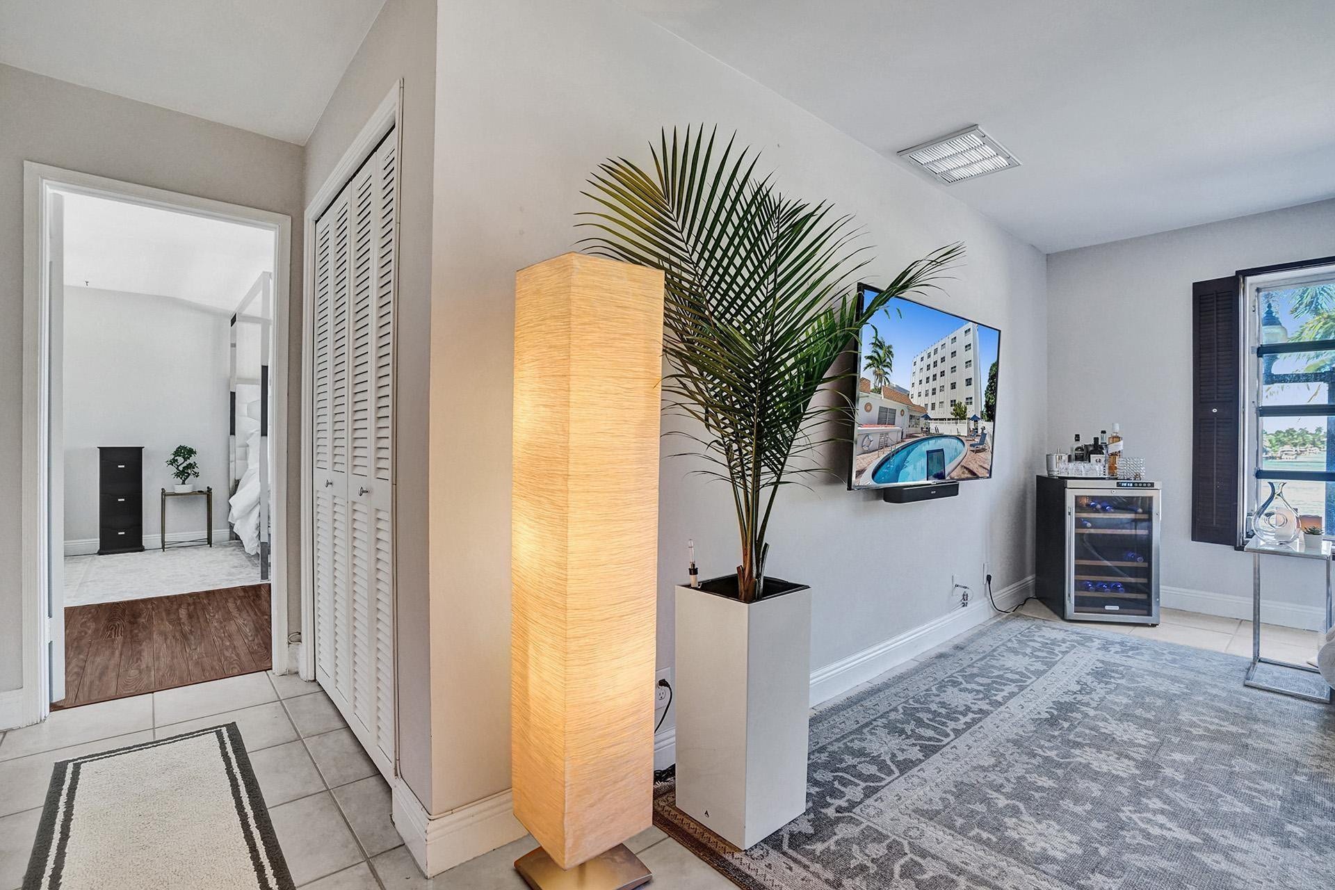 SMALL HALLWAY LEADS TO LARGE BEDROOM.