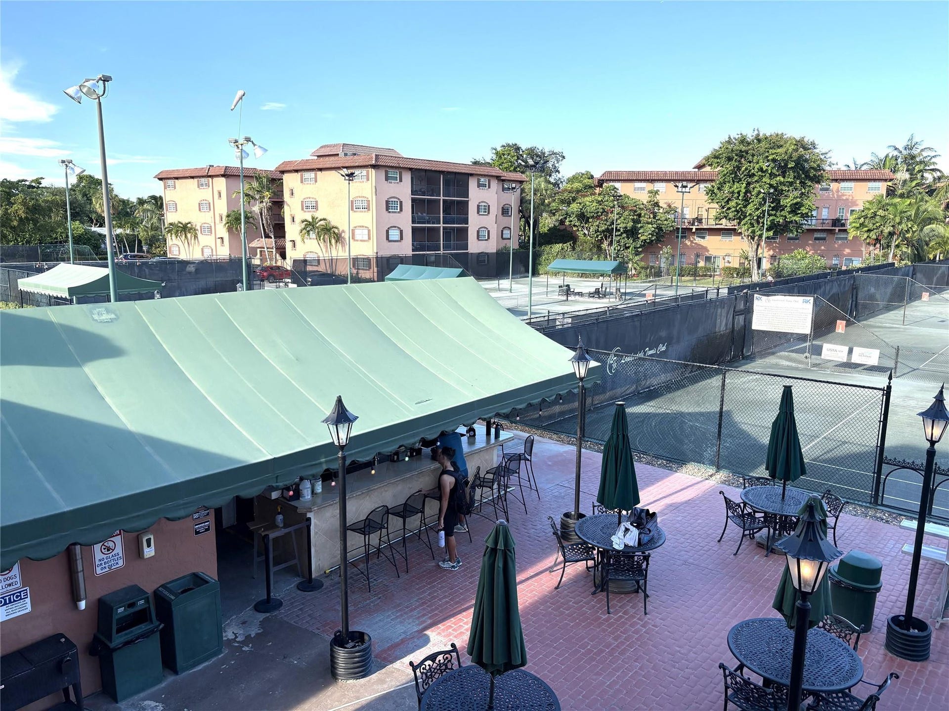 620 Tennis Club Drive, #105, Fort Lauderdale, FL 33311 View of Patio Bar & tennis Cts from Upper Clubhouse