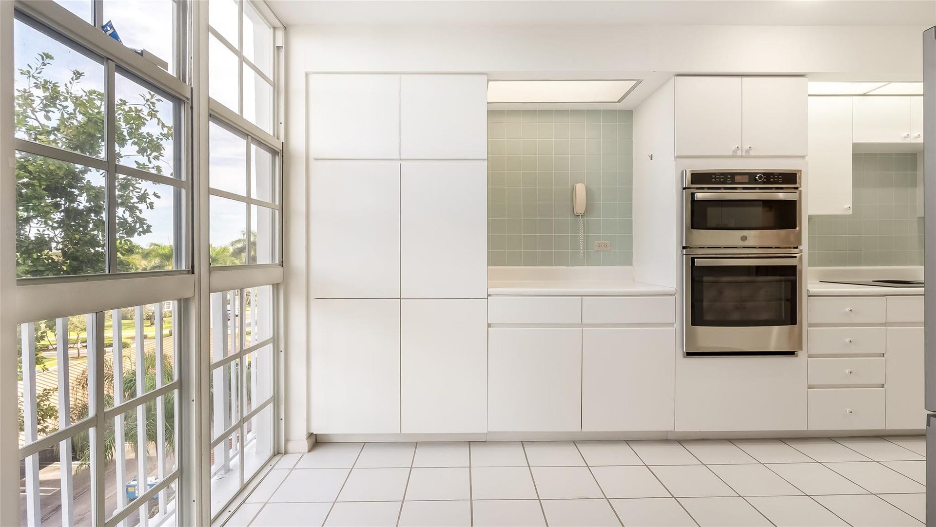 4116 W Palm Aire Drive, #165A, Pompano Beach, FL 33069 Kitchen with floor to ceiling windows allowing natural light and relaxing views.