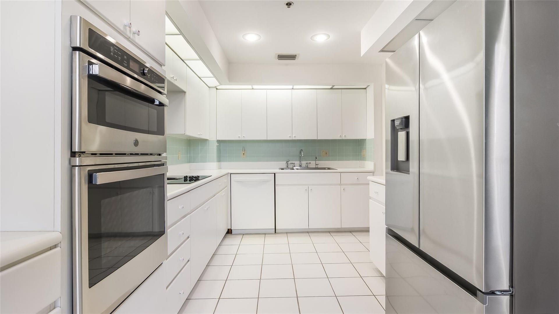 4116 W Palm Aire Drive, #165A, Pompano Beach, FL 33069 Large and functional white modern looking kitchen.