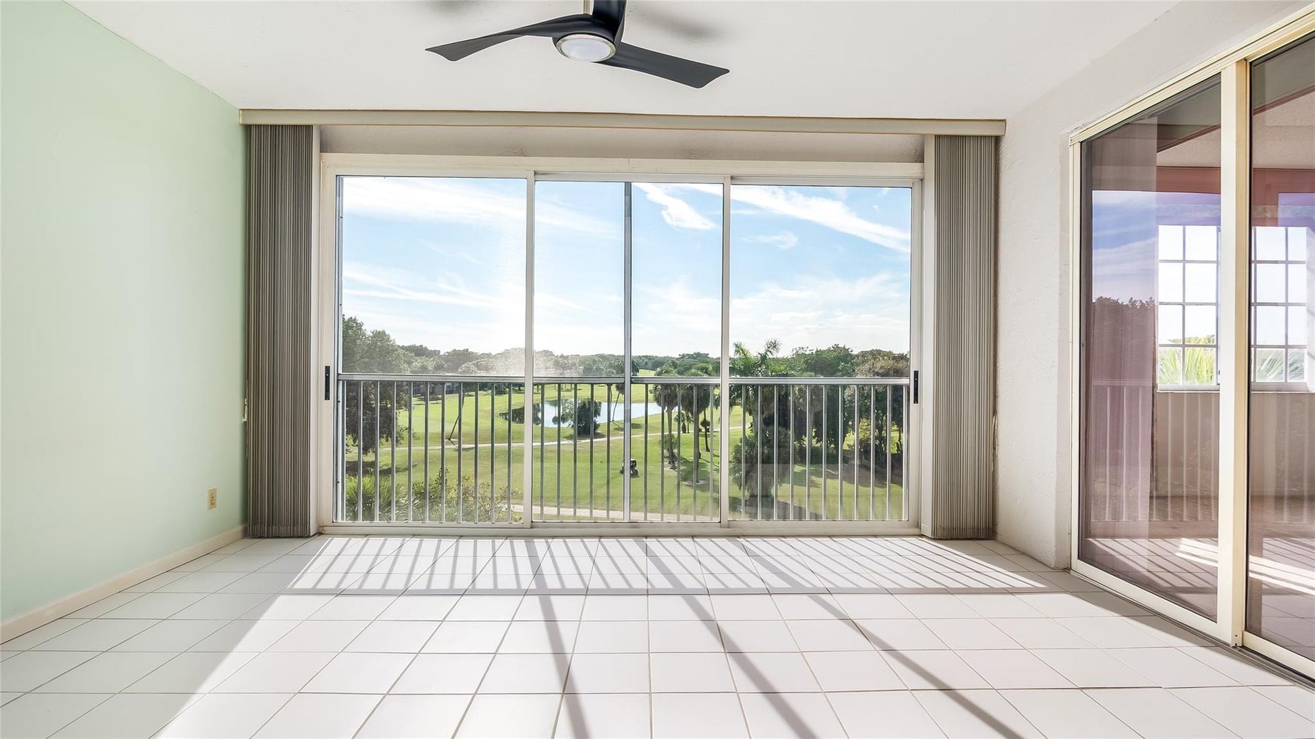 4116 W Palm Aire Drive, #165A, Pompano Beach, FL 33069 Large enclosed balcony off the living room and primary bedroom with golf course views.