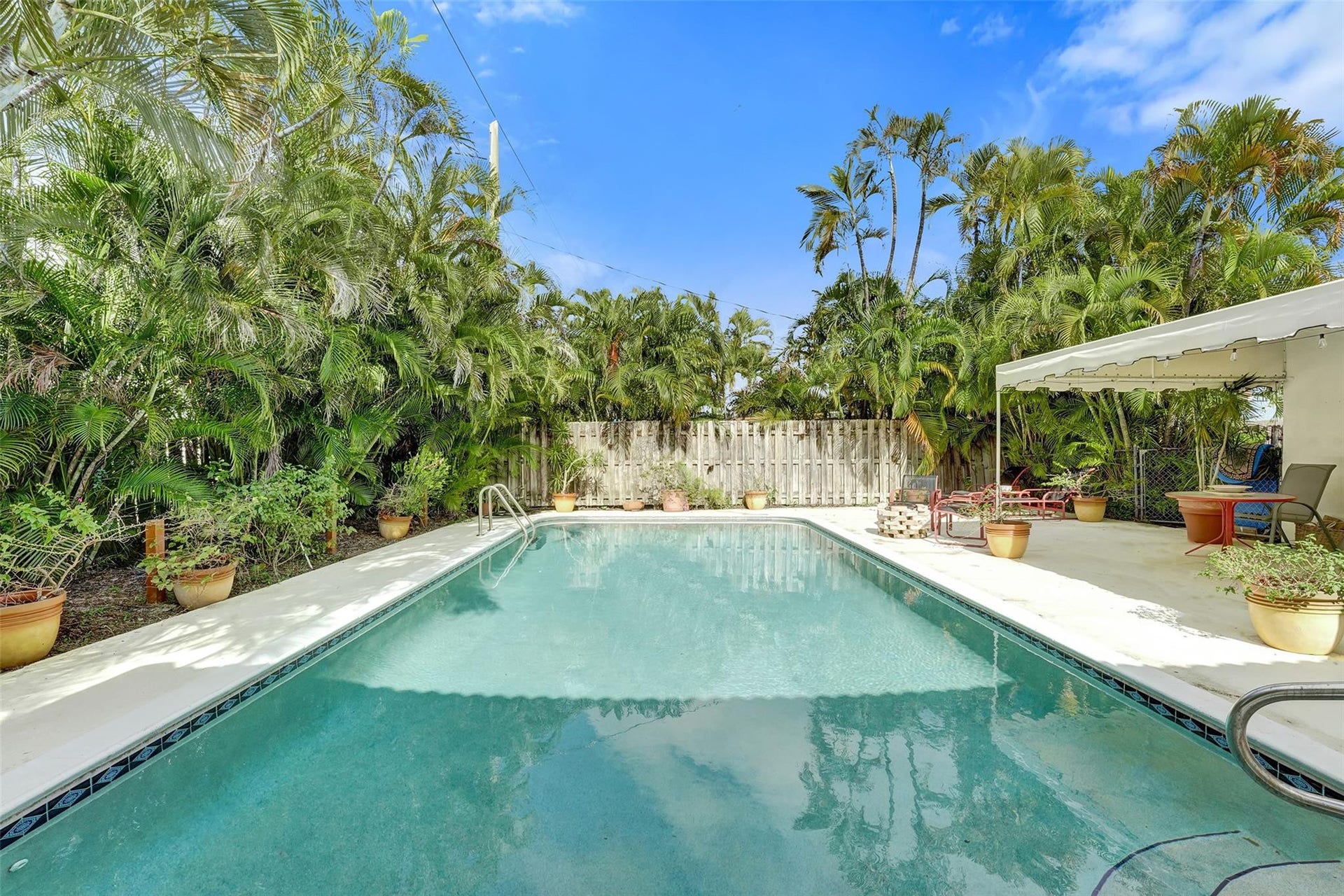 4731 NE 13 Avenue, Oakland Park, FL 33334 Huge sparkling pool surrounded by lush landscaping.