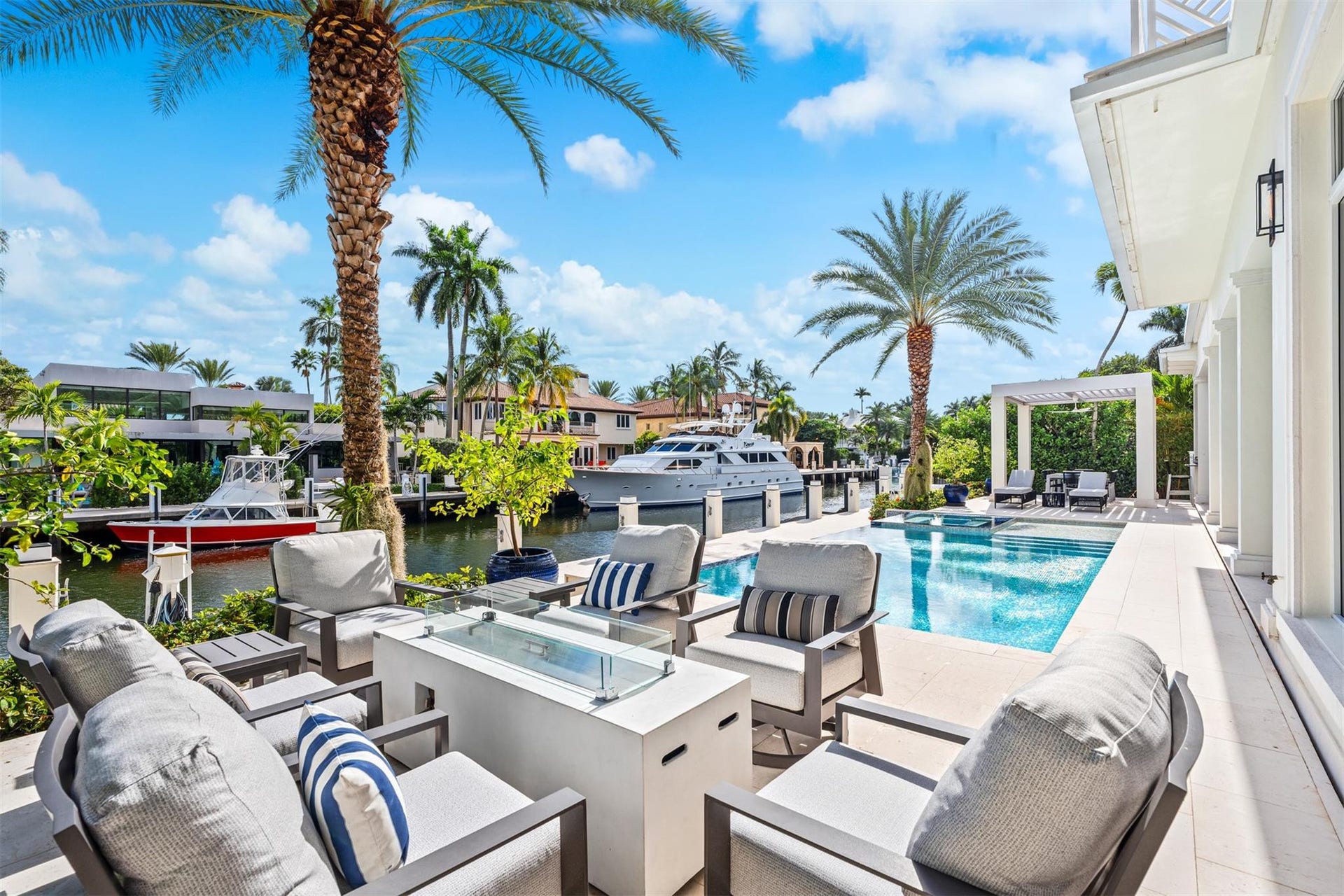 Outdoor gas fire place and seating area creates ambiance and warmth on chilly South Florida nights.