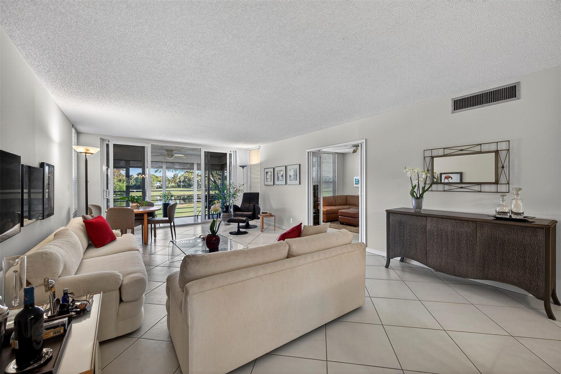 808 Cypress Boulevard, #203, Pompano Beach, FL 33069 living room and balcony facing east receive plenty of natural light