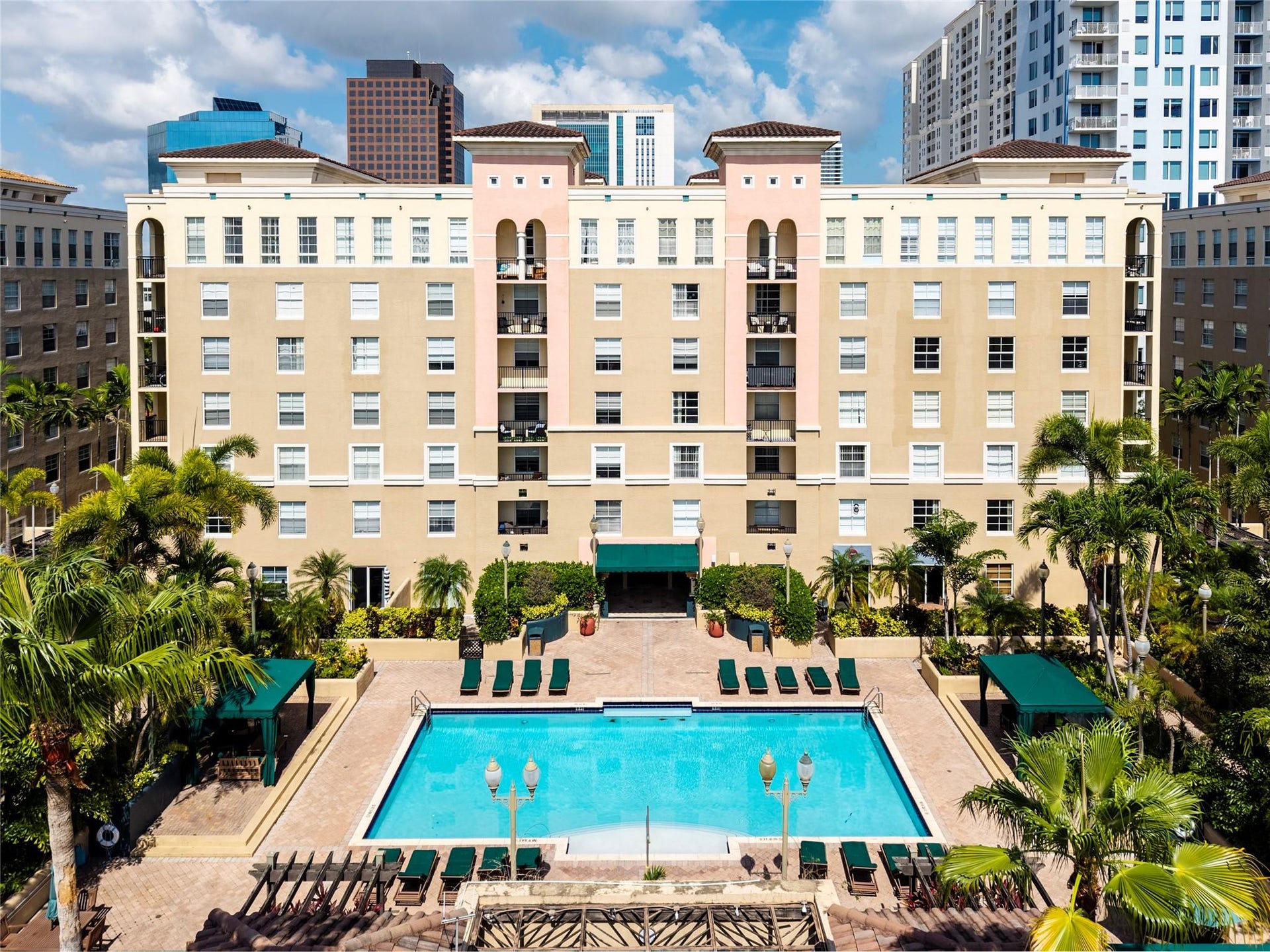 520 SE 5th Avenue, #2404, Fort Lauderdale, FL 33301 Stunning pool area surrounded by lush landscaping, featuring cabanas, a hot tub, shower, and more for ultimate relaxation.