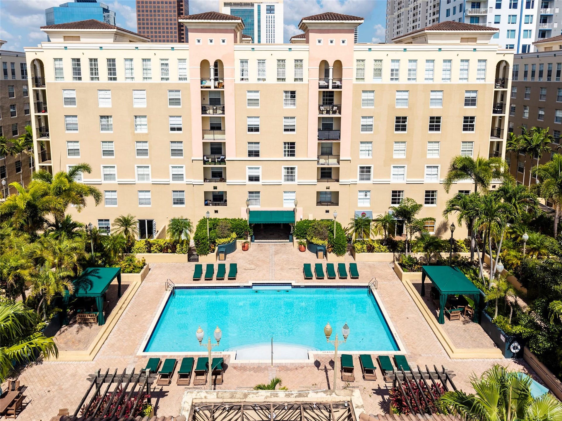 520 SE 5th Avenue, #2404, Fort Lauderdale, FL 33301 Stunning pool area surrounded by lush landscaping, featuring cabanas, a hot tub, shower, and more for ultimate relaxation.