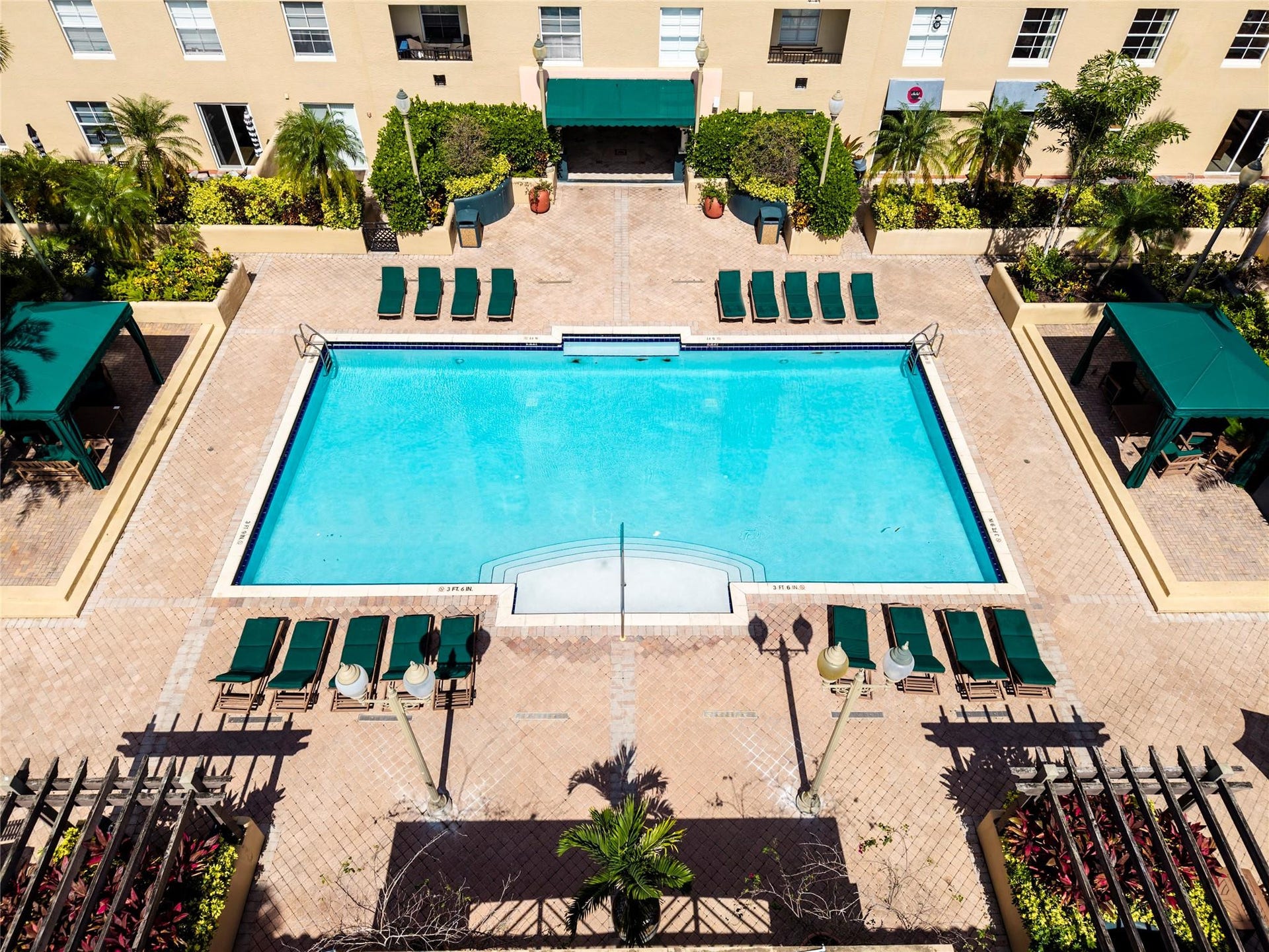 520 SE 5th Avenue, #2404, Fort Lauderdale, FL 33301 Stunning pool area surrounded by lush landscaping, featuring cabanas, a hot tub, shower, and more for ultimate relaxation.