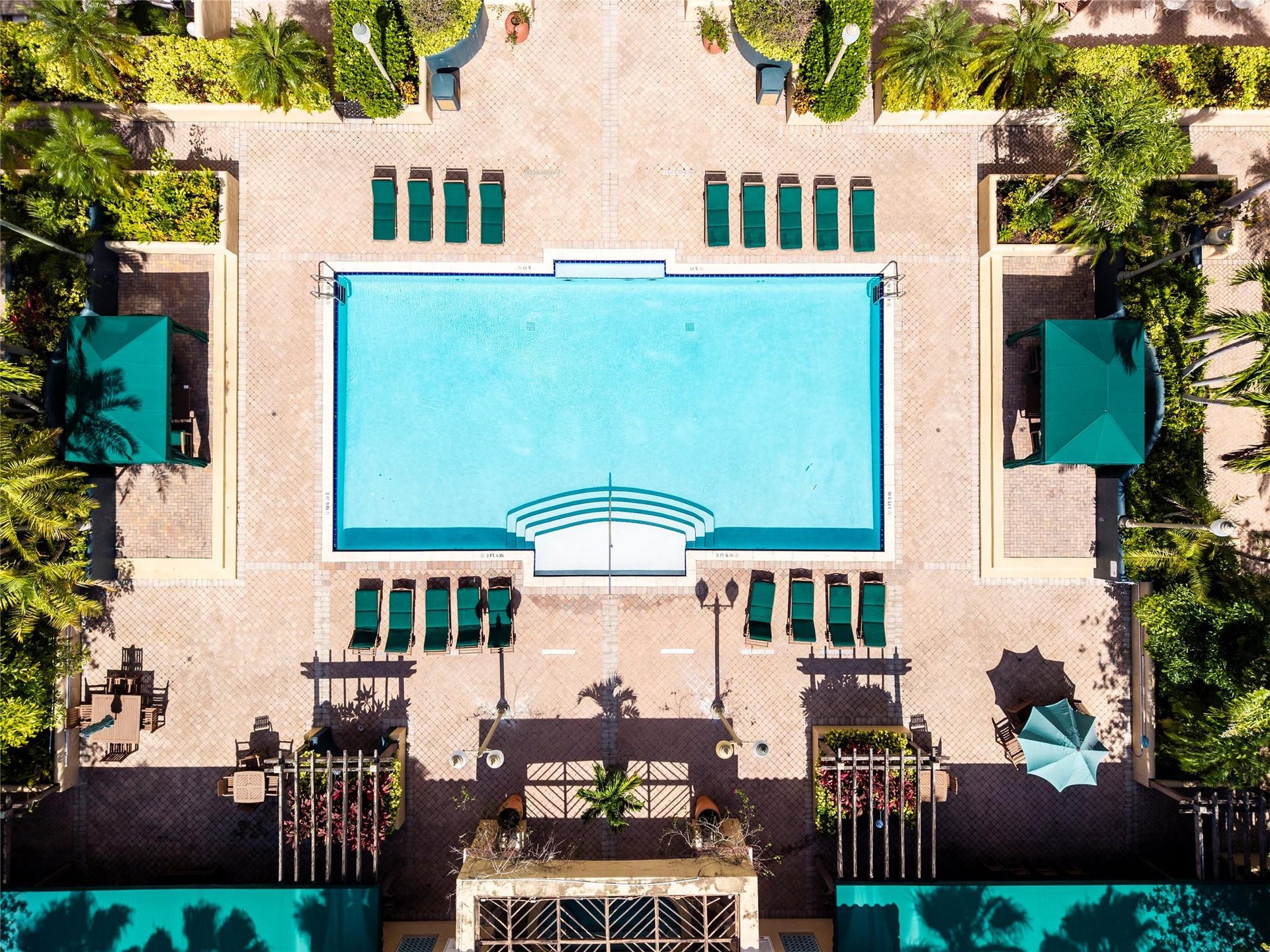 520 SE 5th Avenue, #2404, Fort Lauderdale, FL 33301 Stunning pool area surrounded by lush landscaping, featuring cabanas, a hot tub, shower, and more for ultimate relaxation.