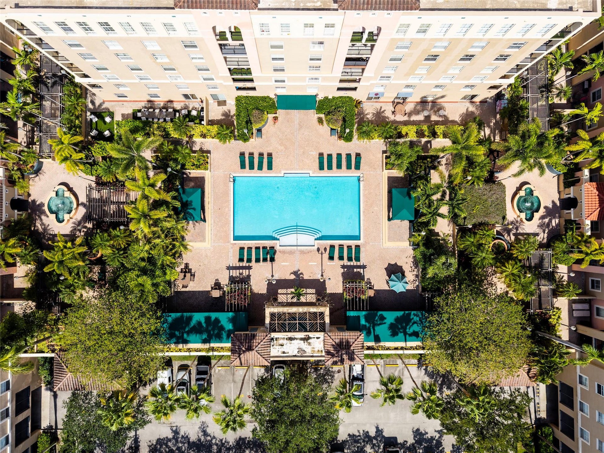 520 SE 5th Avenue, #2404, Fort Lauderdale, FL 33301 Stunning pool area surrounded by lush landscaping, featuring cabanas, a hot tub, shower, and more for ultimate relaxation.