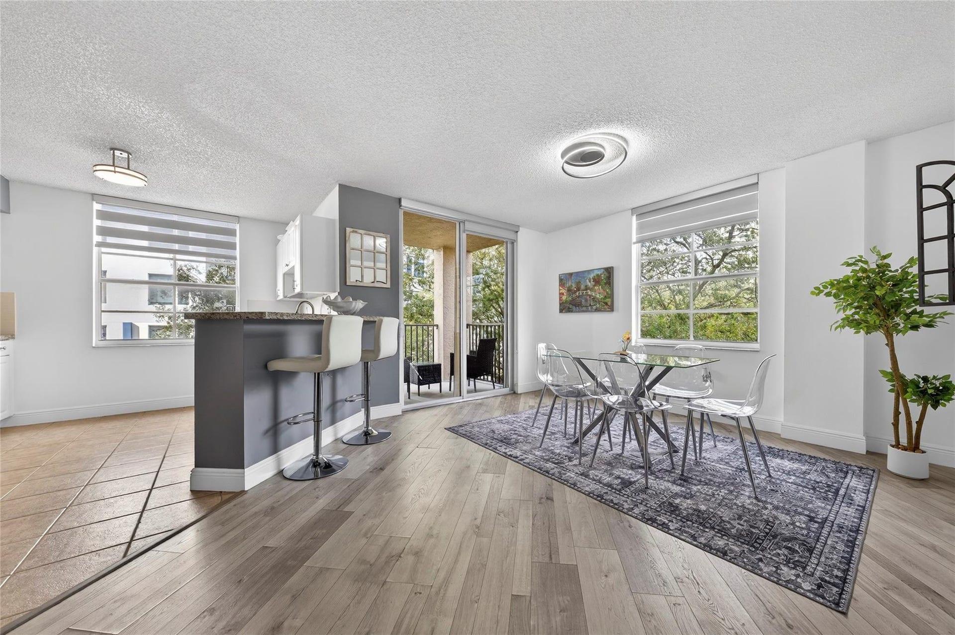 520 SE 5th Avenue, #2404, Fort Lauderdale, FL 33301 Bright, open living and dining area featuring corner-unit privacy, treetop views, and seamless access to the private balconyperfect for everyday living and entertaining.