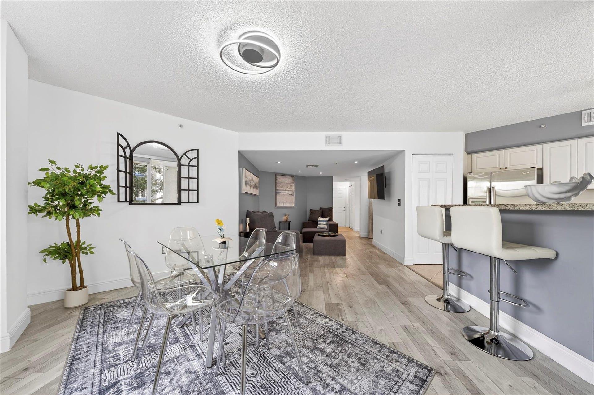 520 SE 5th Avenue, #2404, Fort Lauderdale, FL 33301 Bright, open living and dining area featuring corner-unit privacy, treetop views, and seamless access to the private balconyperfect for everyday living and entertaining.