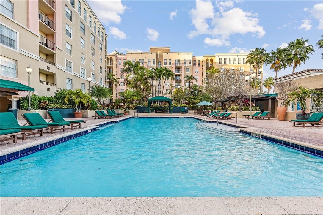 520 SE 5th Avenue, #2404, Fort Lauderdale, FL 33301 Stunning pool area surrounded by lush landscaping, featuring cabanas, a hot tub, shower, and more for ultimate relaxation.