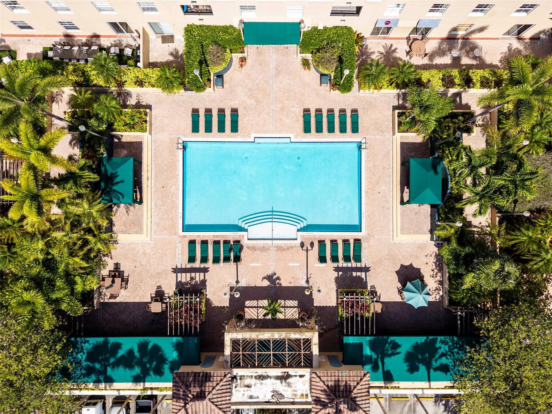 520 SE 5th Avenue, #2404, Fort Lauderdale, FL 33301 Stunning pool area surrounded by lush landscaping, featuring cabanas, a hot tub, shower, and more for ultimate relaxation.