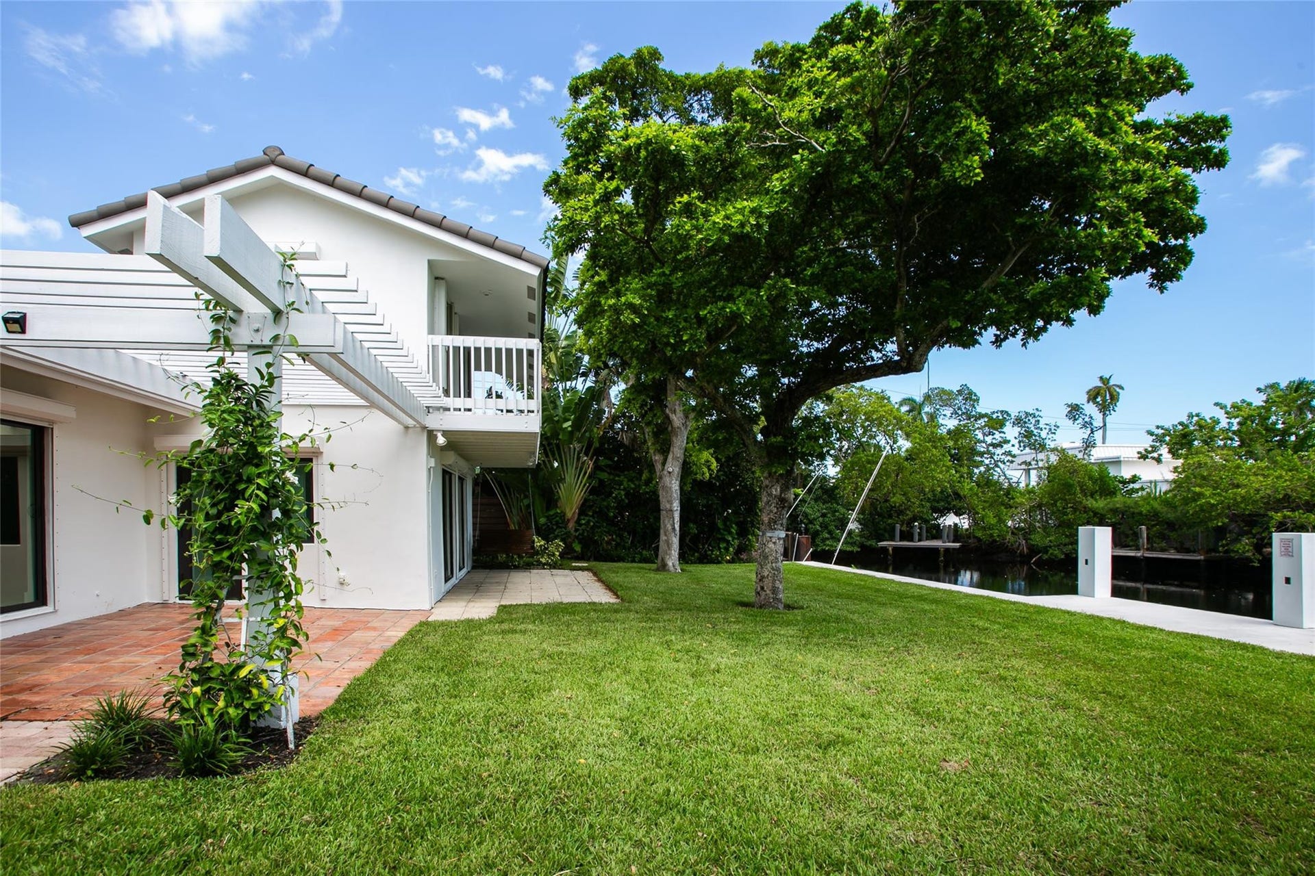 Rear of house with Double patio and expansive lawn