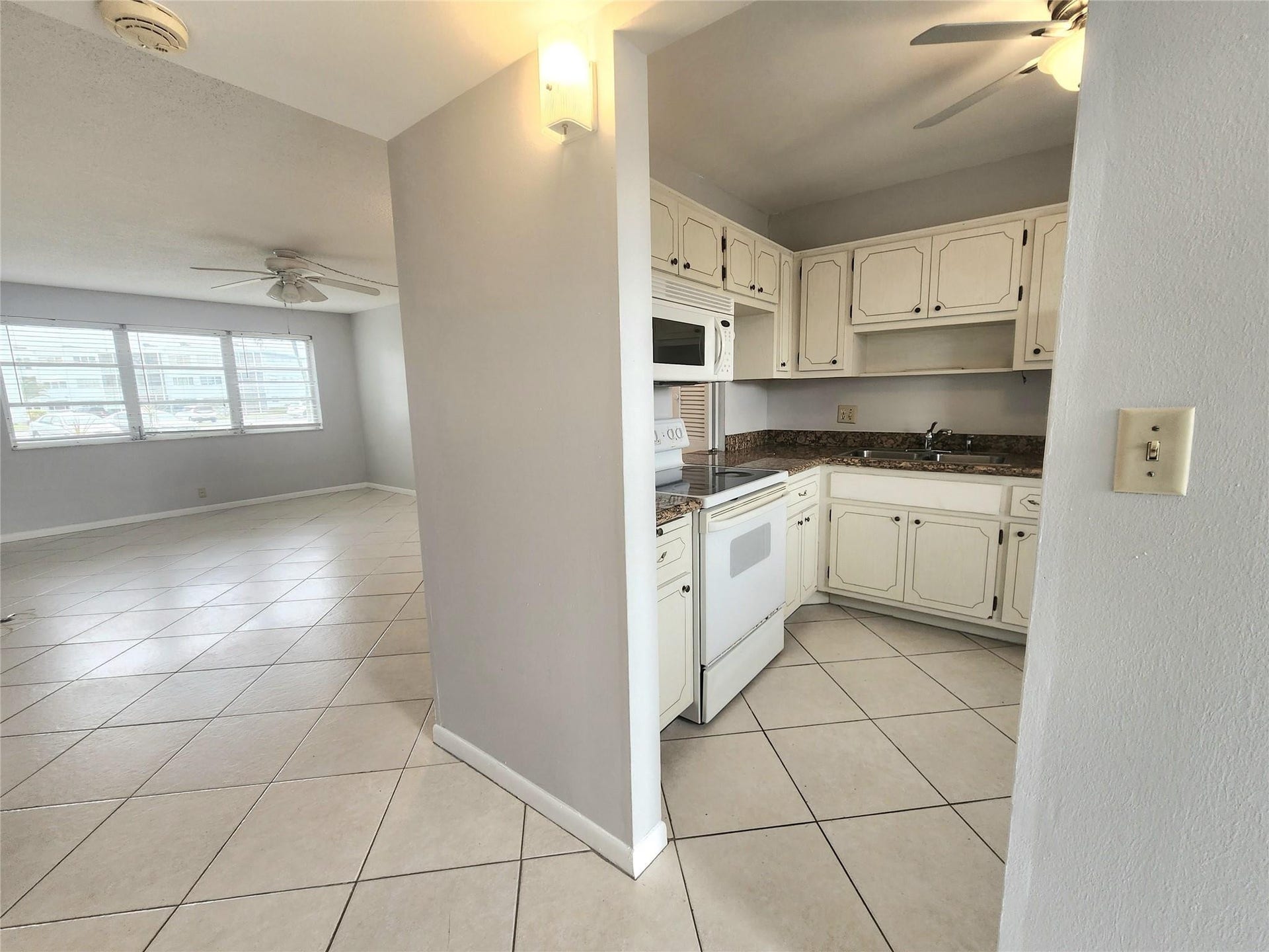 2223 Park Lane, #105, Hollywood, FL 33021 Easy access to the kitchen from the foyer and living/dining areas make entertaining a breeze. This unit has been freshly painted in a soft gray.