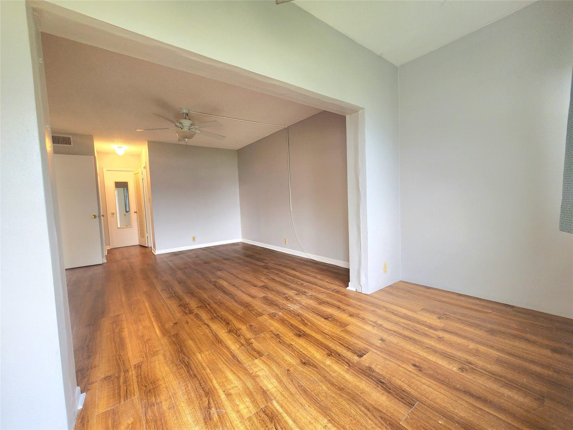 2223 Park Lane, #105, Hollywood, FL 33021 The expansive primary suite enjoys beautiful laminate flooring, first floor access to the garden area, and plenty of space for even your largest furnishings. It also has ensuite access to the bath, a large walk in closet and extra seating area .