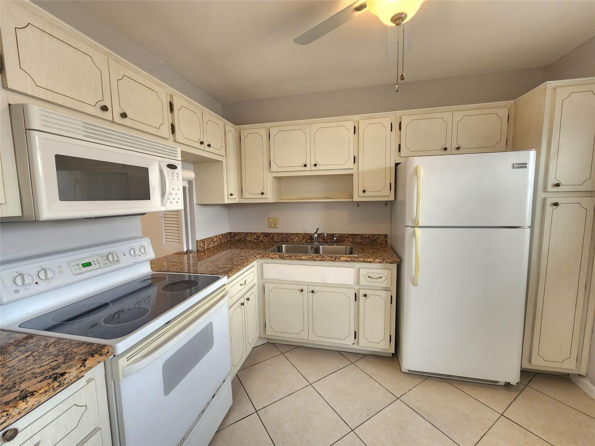 2223 Park Lane, #105, Hollywood, FL 33021 The kitchen also offers white appliances, a stainless sink and neutral tile.