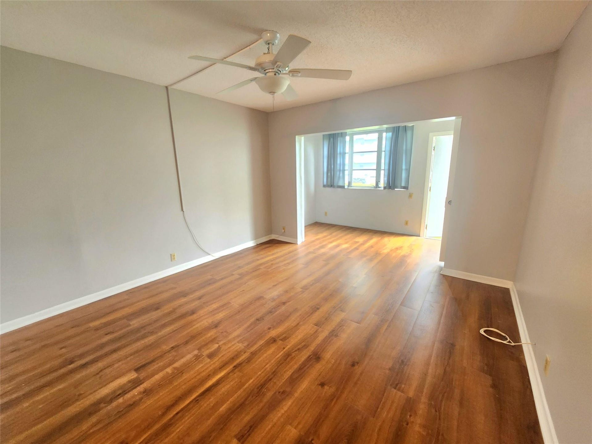 2223 Park Lane, #105, Hollywood, FL 33021 At the rear of the property, the primary suite has direct access to the outside garden area, large window, and extra square footage that can be enjoyed as a seating area.