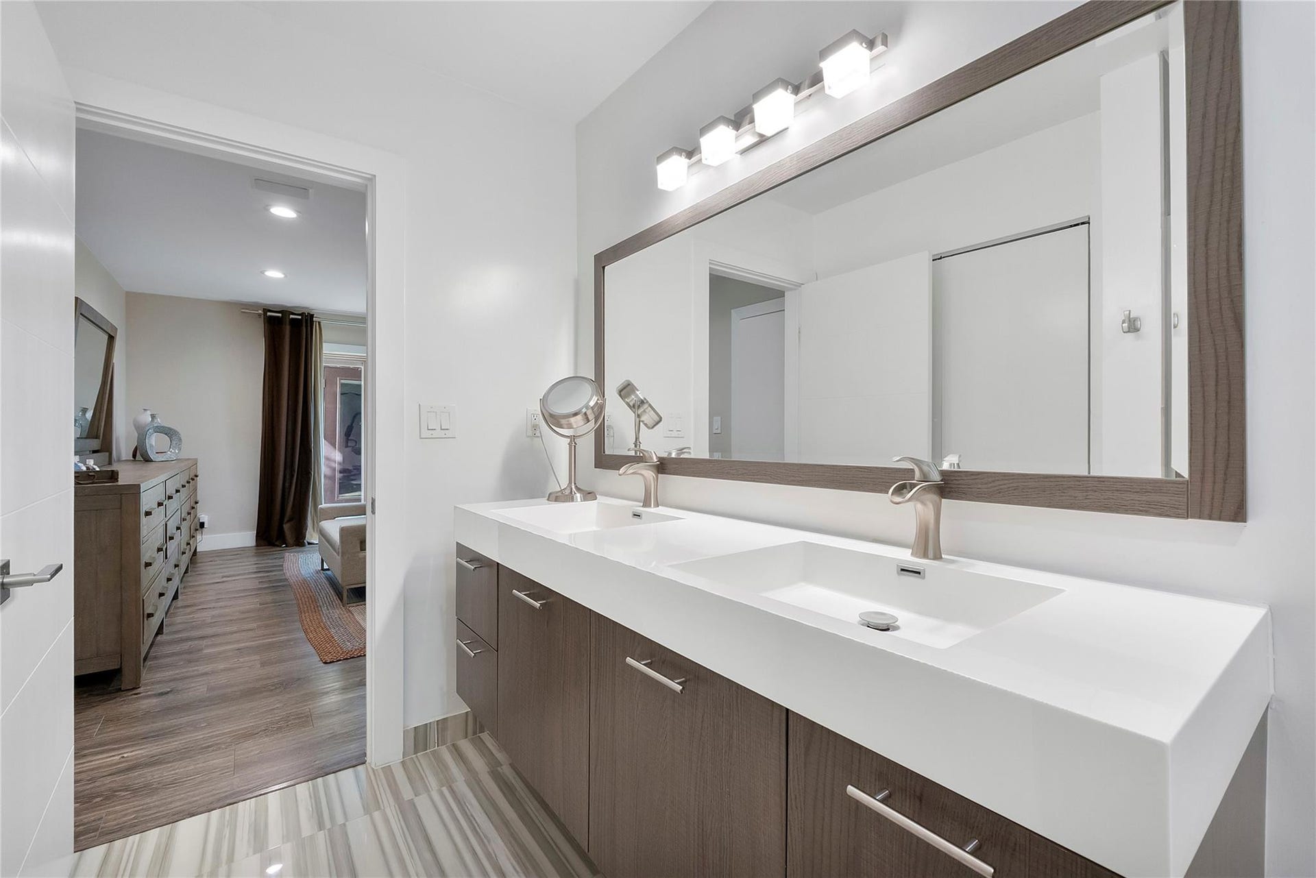 5351 Godfrey Road, Parkland, FL 33067 Double vanities and stylish modern wooden cabinets with matching wooden framed mirror & chrome hardware, Porcelain tile flooring in the bathroom and waterproof premium lamintae is all bedrooms and living areas,
