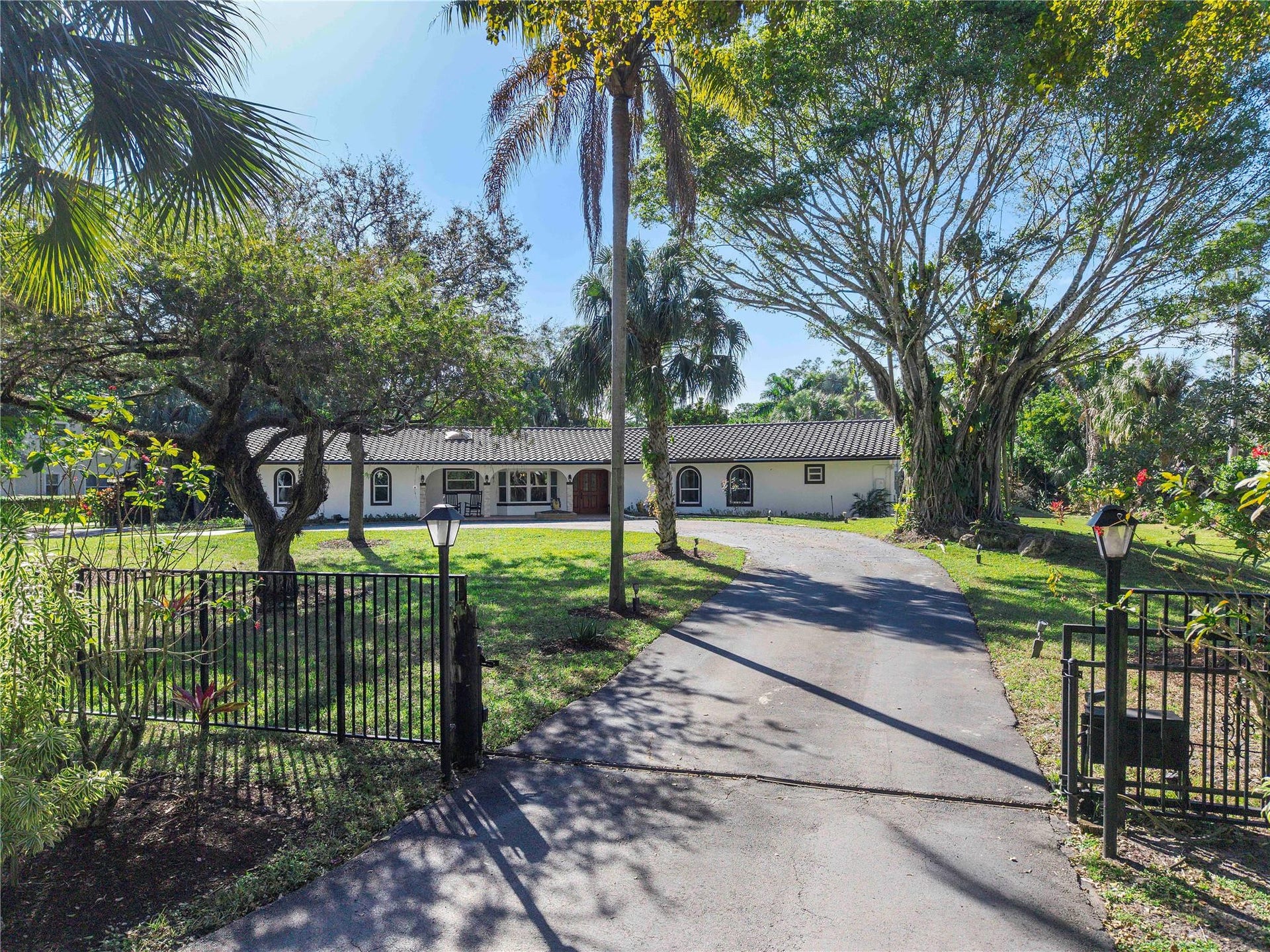 5351 Godfrey Road, Parkland, FL 33067 The front of the home with lots of open garden for children to play, Electric gate & fully fenced surrounded gardens with a circular driveway for at least 16 cars