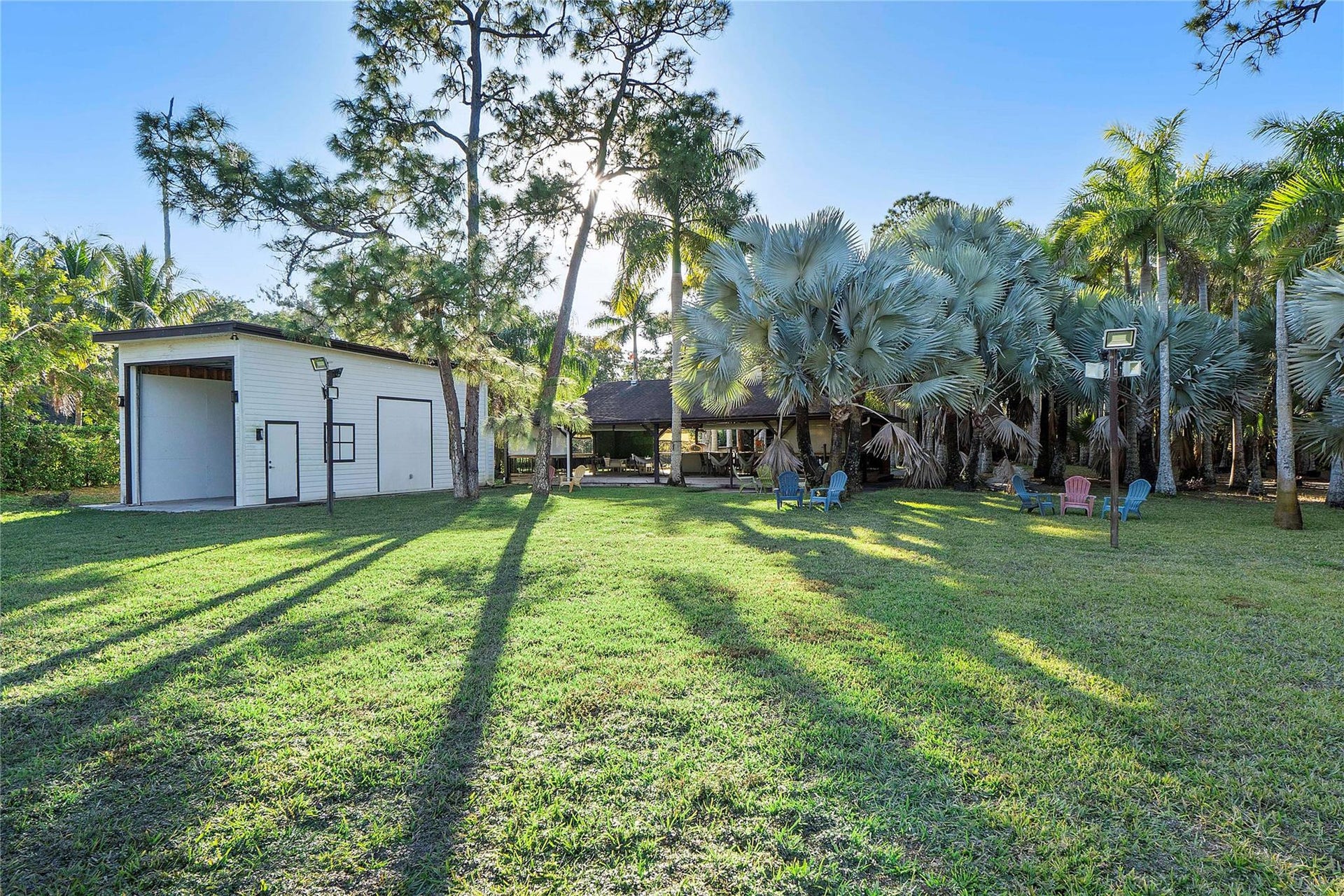 5351 Godfrey Road, Parkland, FL 33067 This is a view of the RV Hanger and the 1200 sq foot gazebo wooden deck Tiki-style great entertainment area that was originally built as a Barn for horses & can easily be renovated back to a barn or used as an arts & crafts meeting place or similar Parkland ladies get togethers or meeting or conferences, The gazebo is equipped with a real Pizza oven and BBQ Griller and juicers and lots of entertaining spaces and seats and tables, You could even hold Karaoke nights or have a band perform for your guests