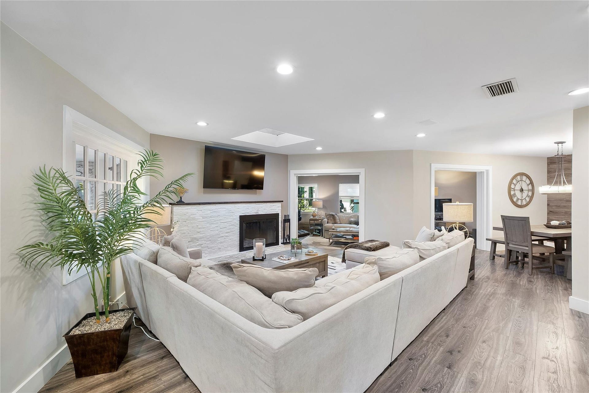 5351 Godfrey Road, Parkland, FL 33067 Huge living room with a stylish modern fireplace for those chilly movie nights by the fire, Can you see the open floorplan and all the open rooms that are adjacent to the living room?there is another beauty to the left of the couch also, such a pretty home