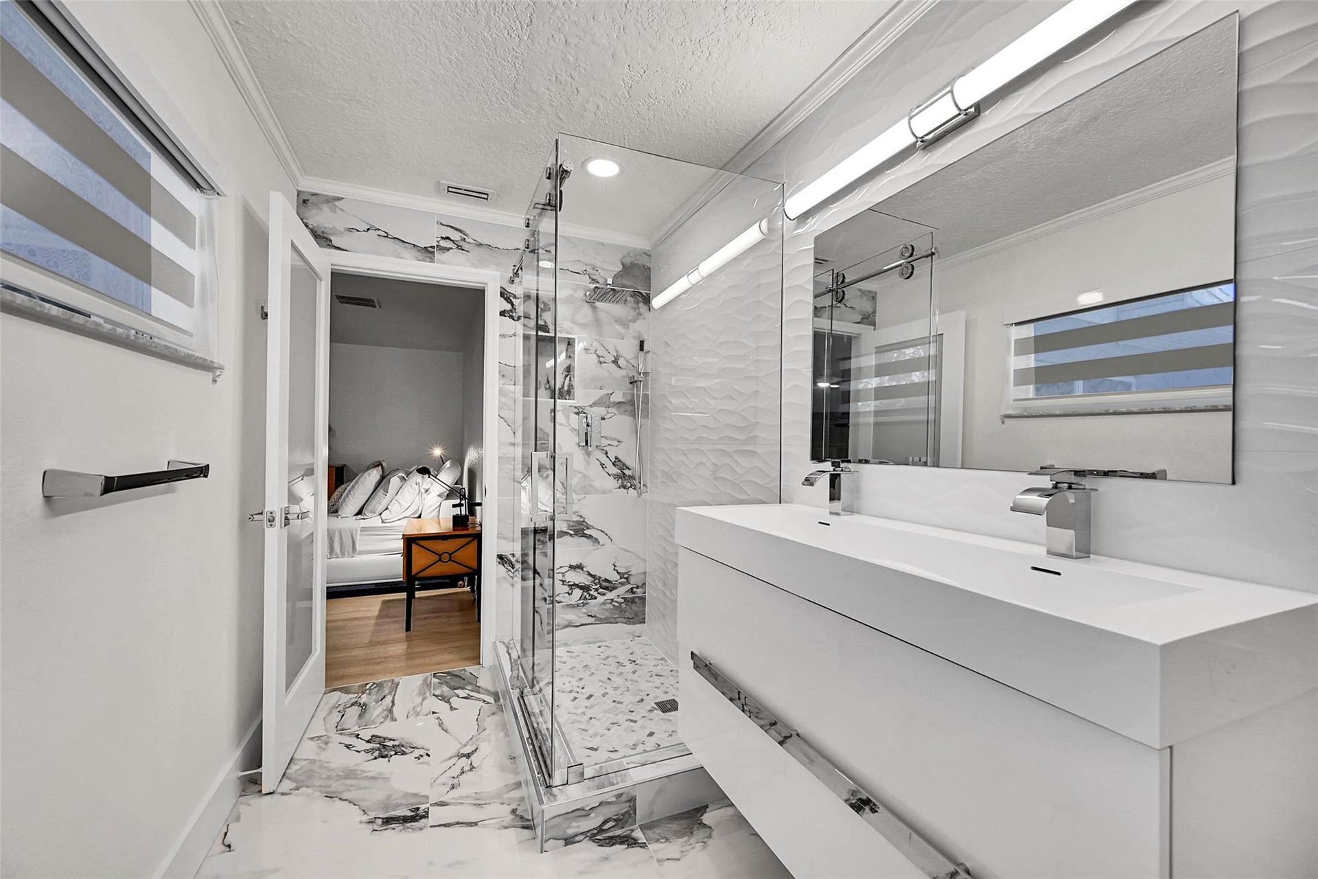 3044 NE 15th Terrace, Oakland Park, FL 33334 New Carrera tile and double sink primary bath