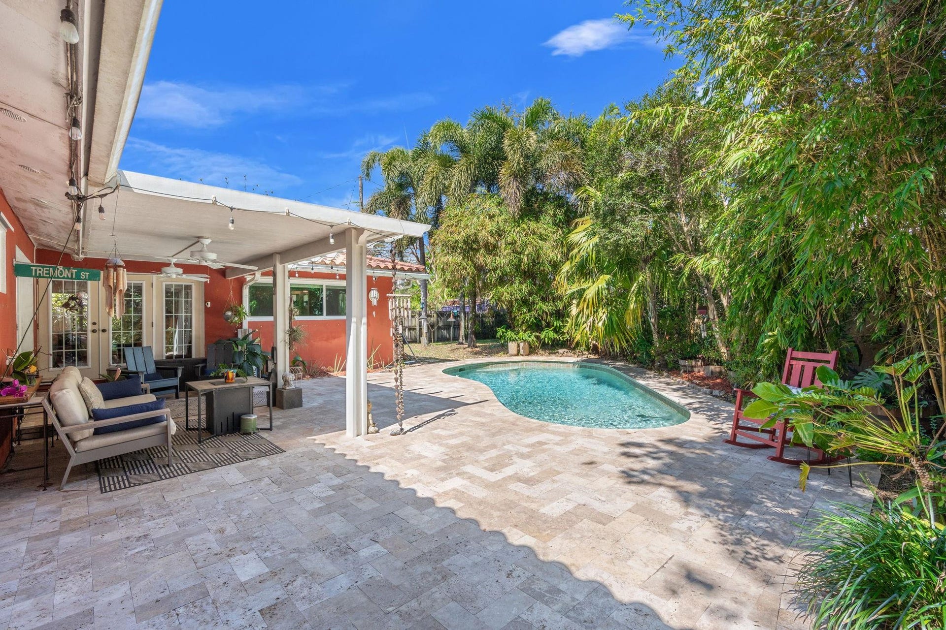 2956 NW 6th Terrace, Wilton Manors, FL 33311 Expansive backyard with pool, covered patio, and landscaped perimeter. Open deck space allows for additional seating and outdoor entertaining.