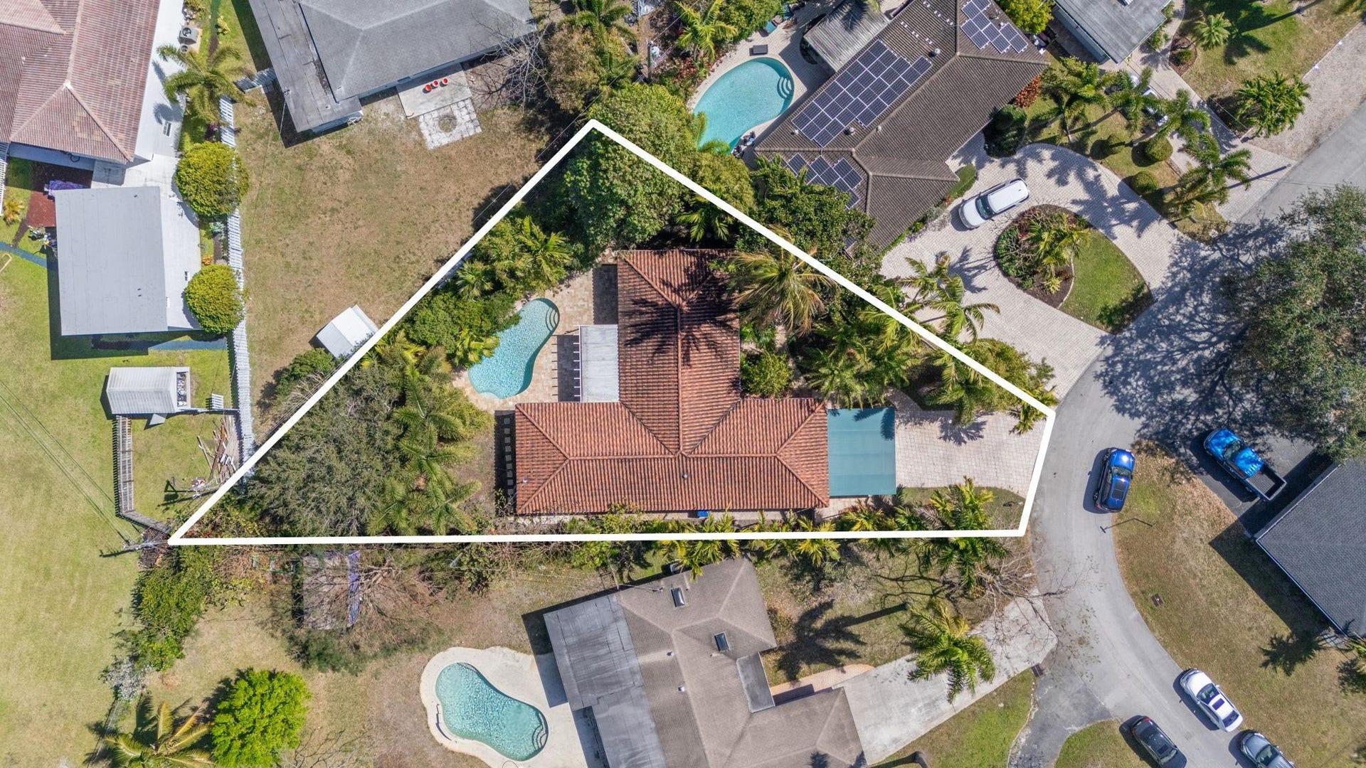 2956 NW 6th Terrace, Wilton Manors, FL 33311 Aerial perspective showcasing the full property footprint, rooflines, pool placement, and surrounding landscaping. Clear view of overall layout.